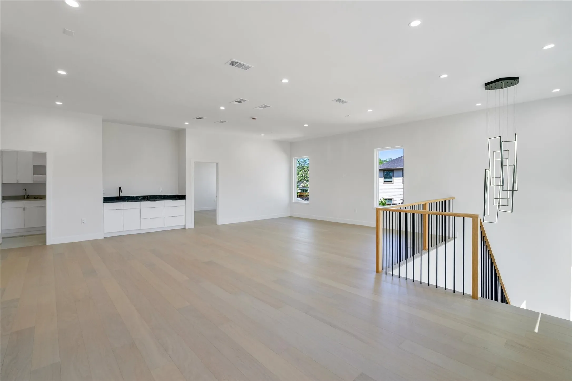 Unfurnished room with light wood finished floors, recessed lighting, and baseboards