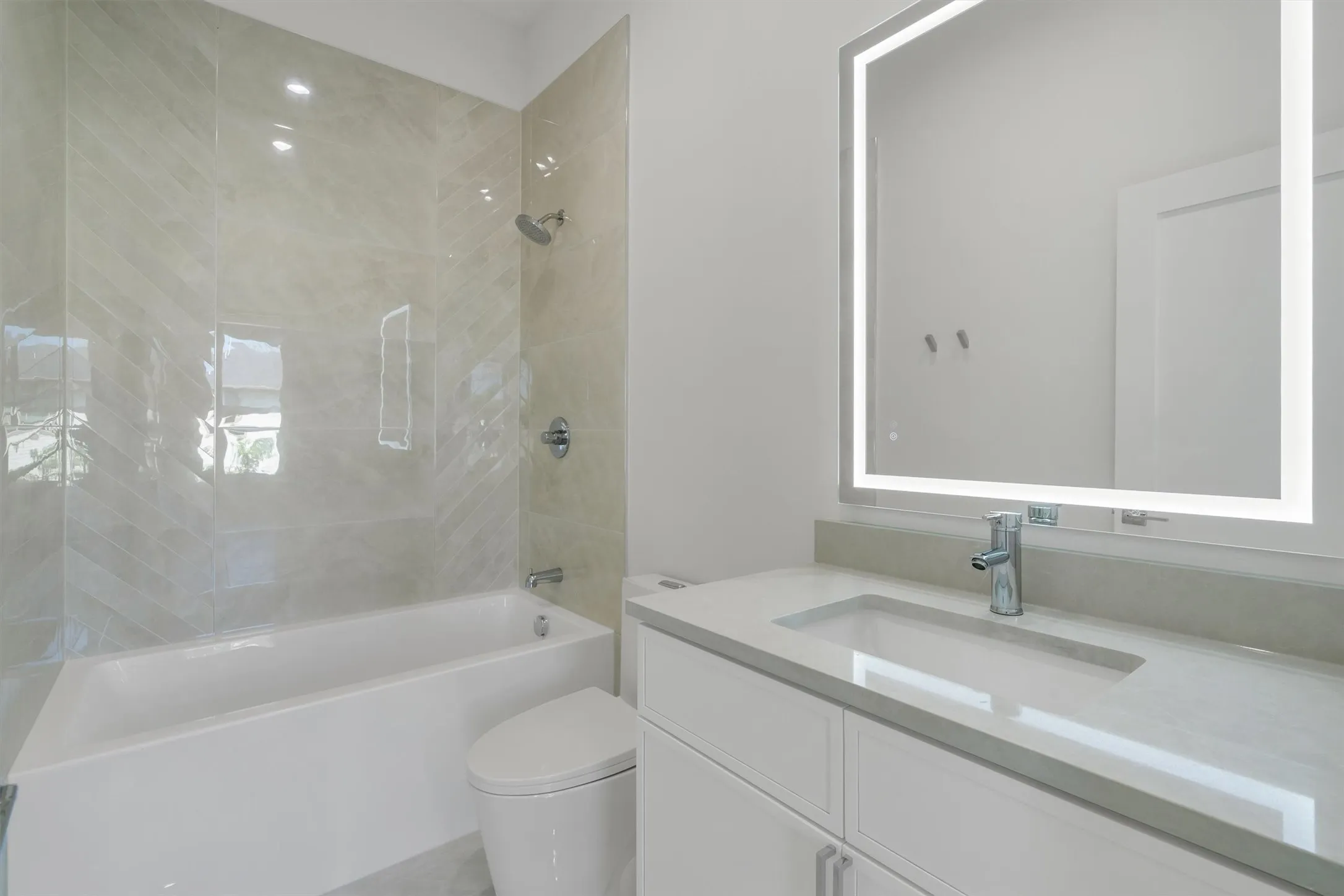 Bathroom with toilet, vanity, and shower / bathtub combination