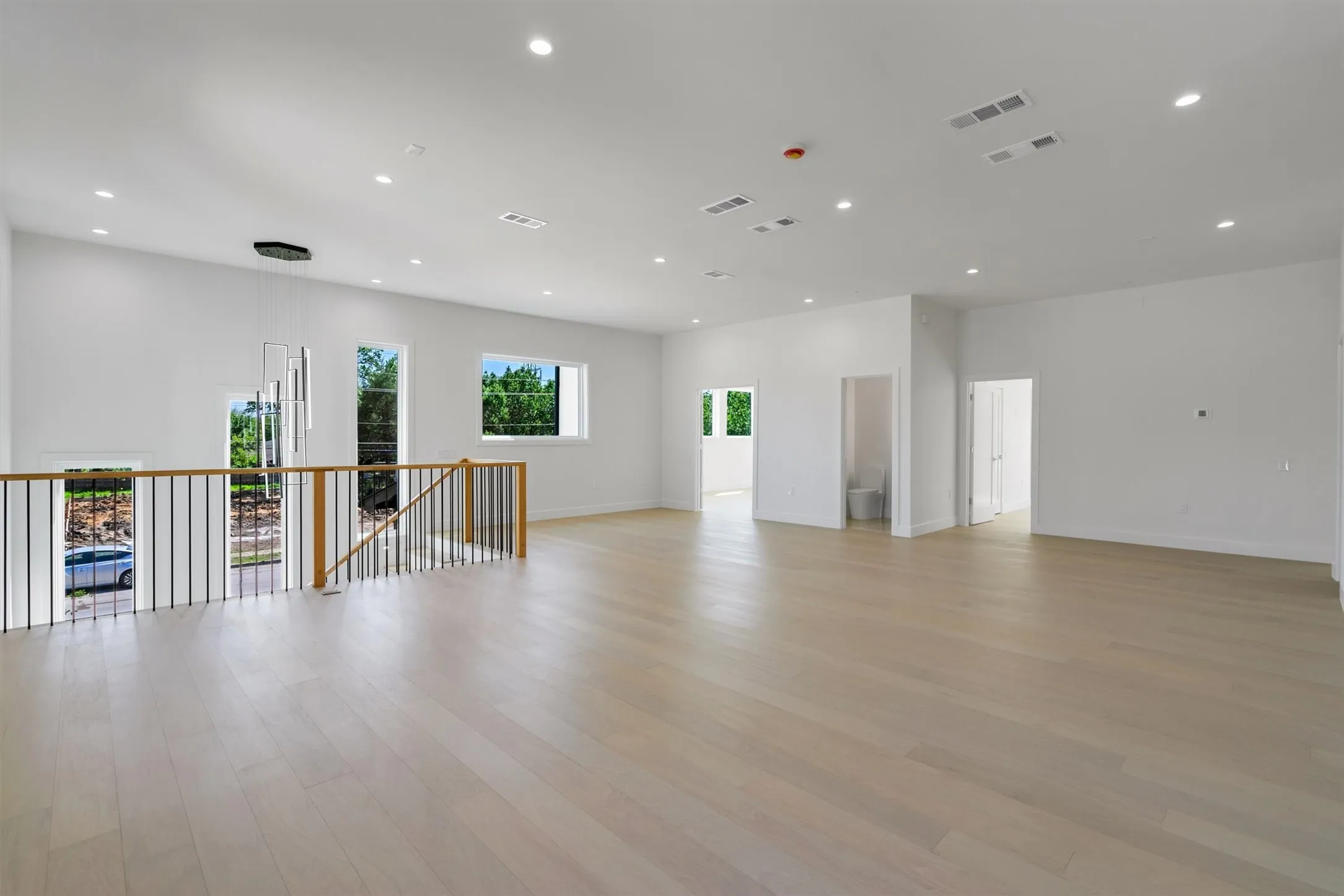 Empty room with light wood-style flooring, recessed lighting, and baseboards