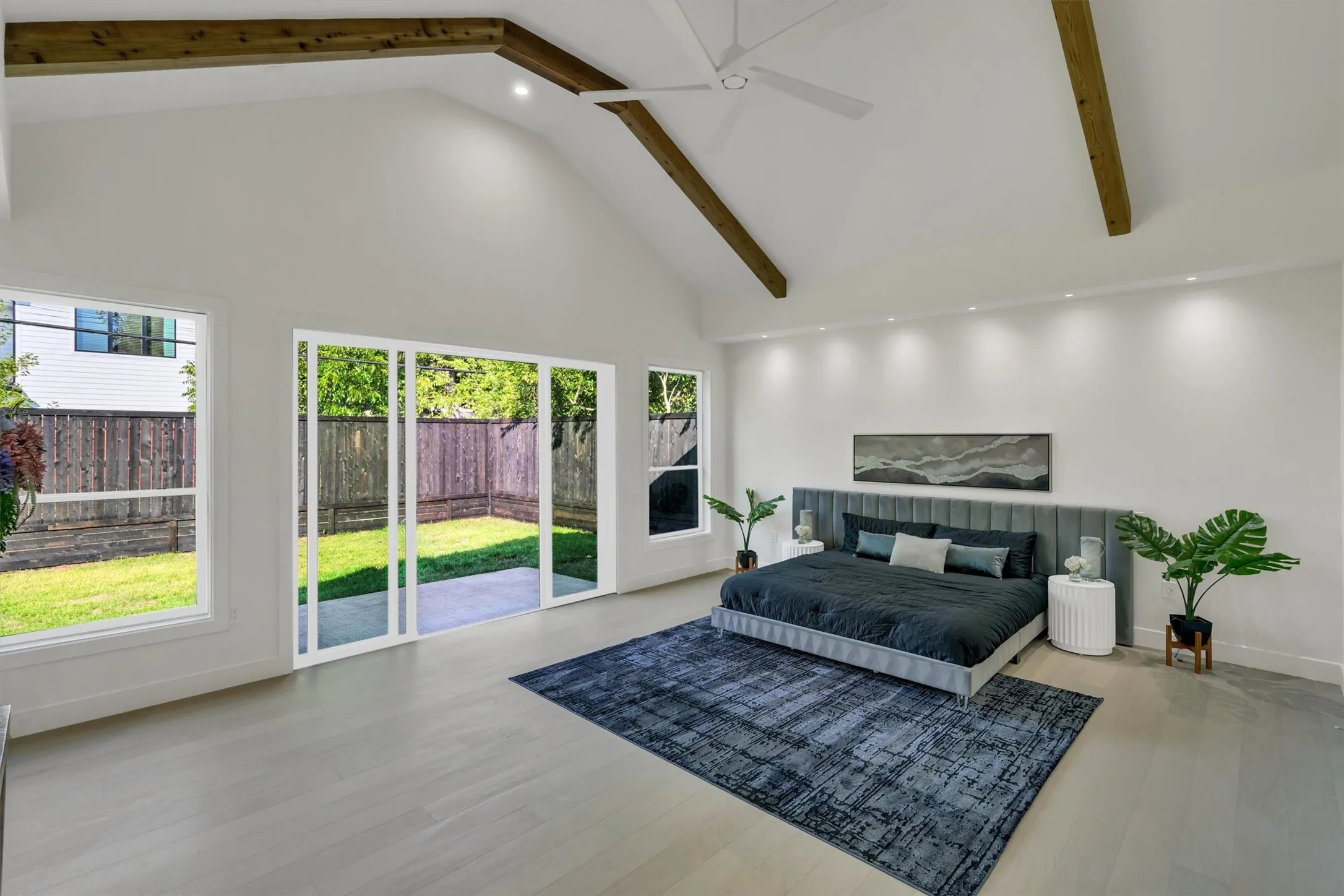 Bedroom with high vaulted ceiling, beam ceiling, wood finished floors, access to outside, and a ceiling fan