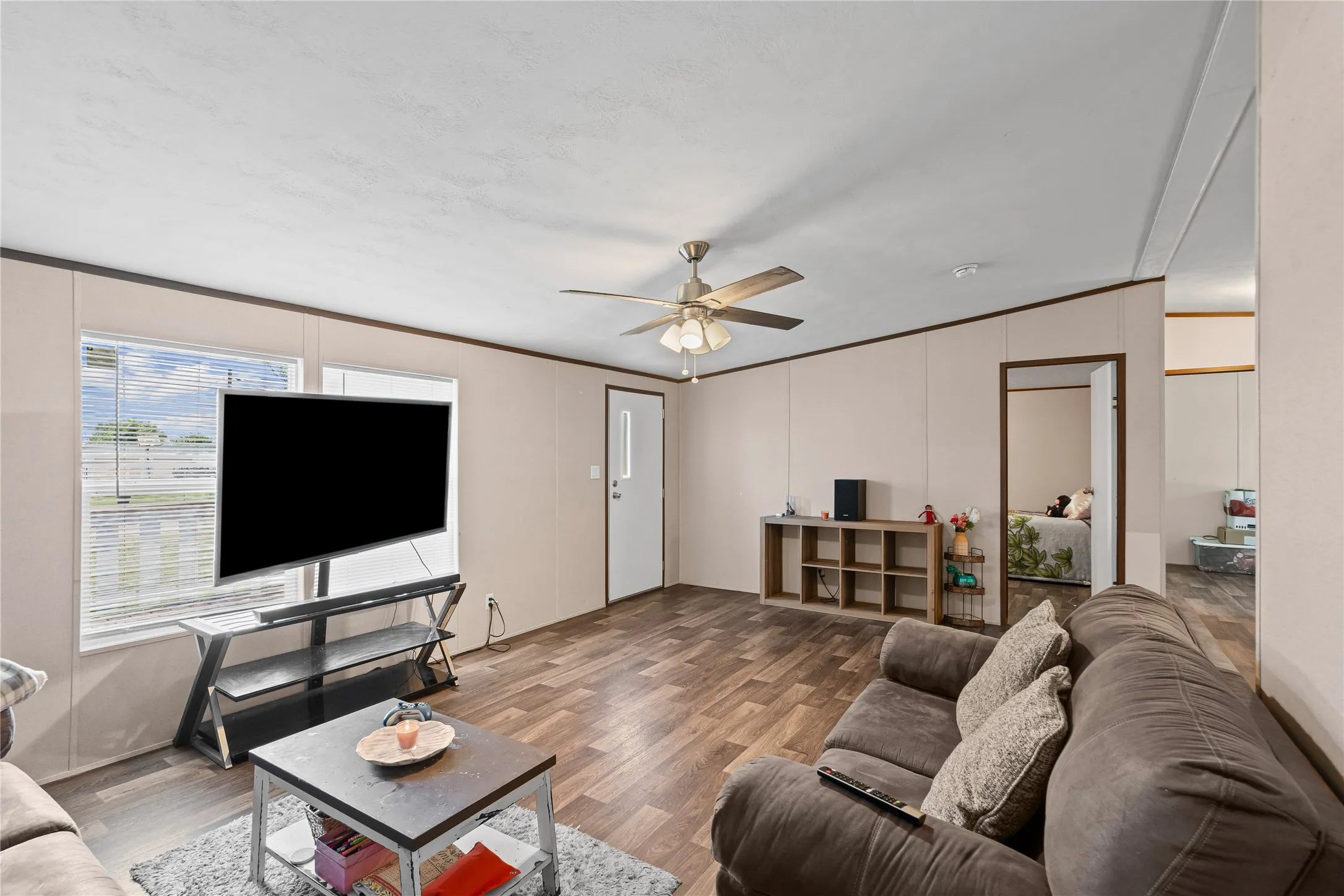 Living area featuring wood finished floors and ceiling fan
