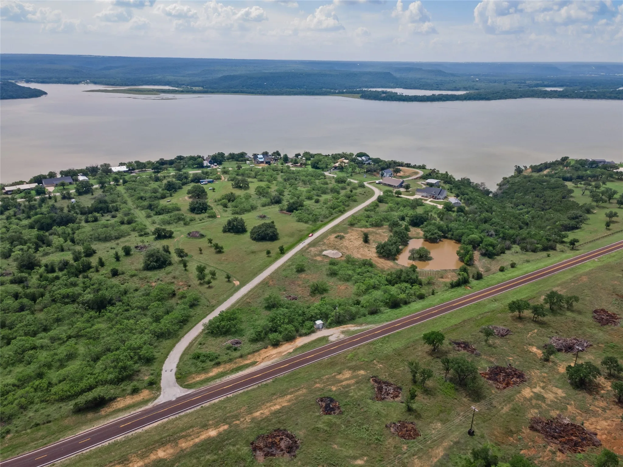 Aerial view of property and surrounding area featuring a nearby body of water