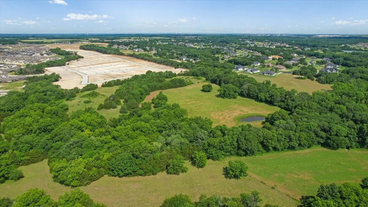 Aerial View of the land at 4195 CR 1001 that butts up against the Subdivision - Eastridges New Phase.