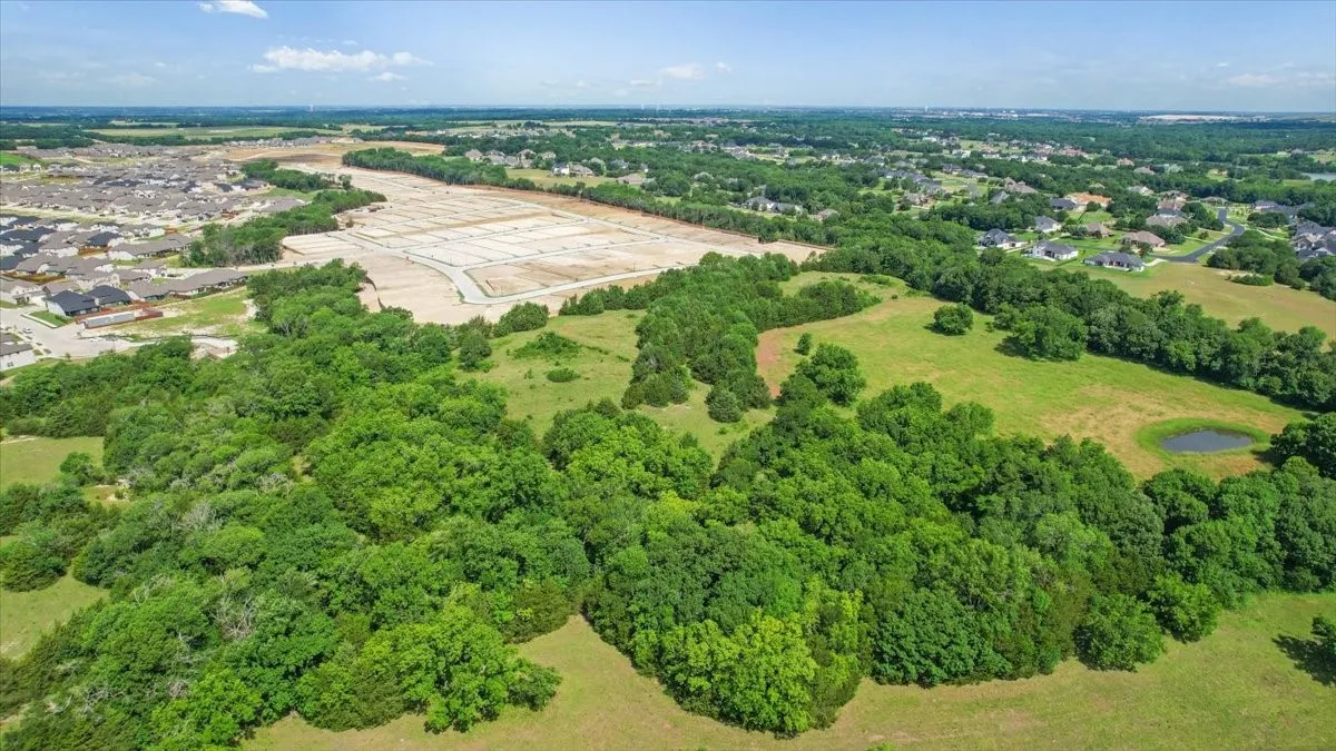 Aerial View of the land at 4195 CR 1001 that butts up against the Subdivision - Eastridges New Phase.