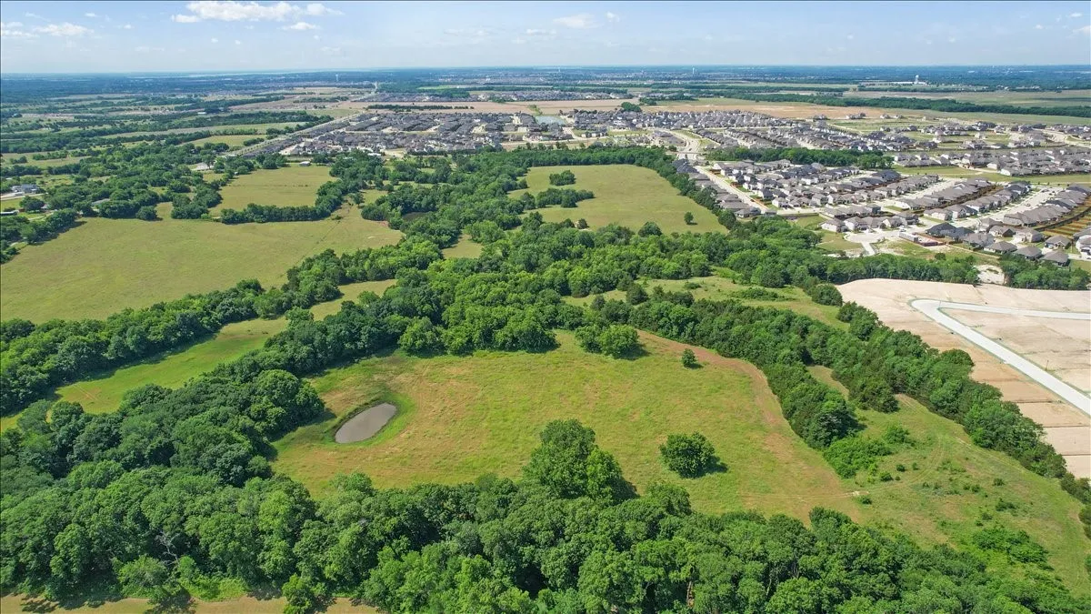 Aerial View of the land at 4195 CR 1001 that butts up against the Subdivision - Eastridges New Phase.
