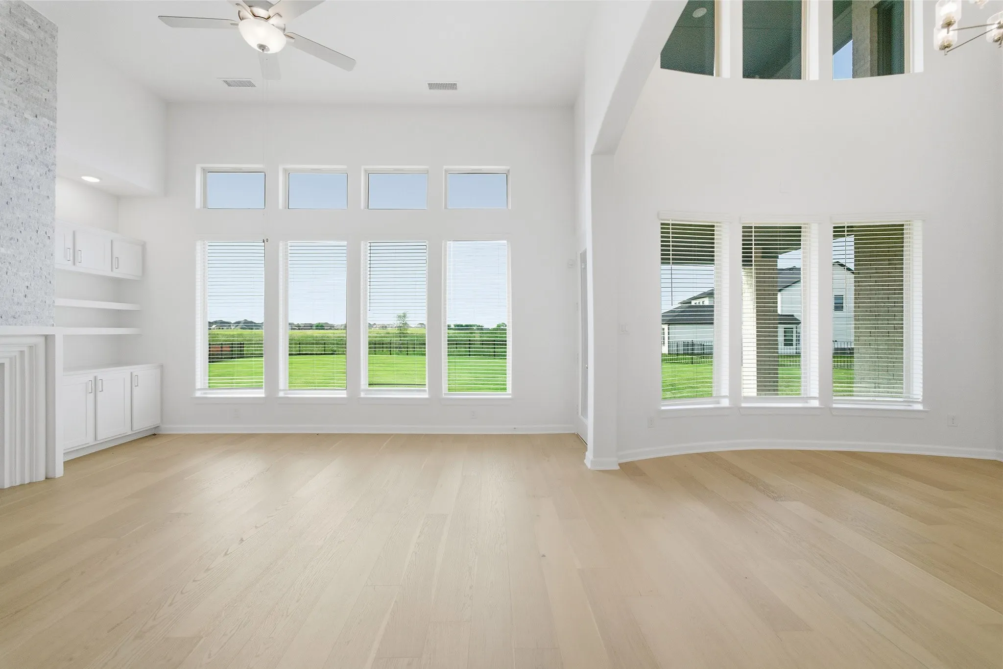 Vaulted ceilings complementing extensive windows with horizontal blinds
