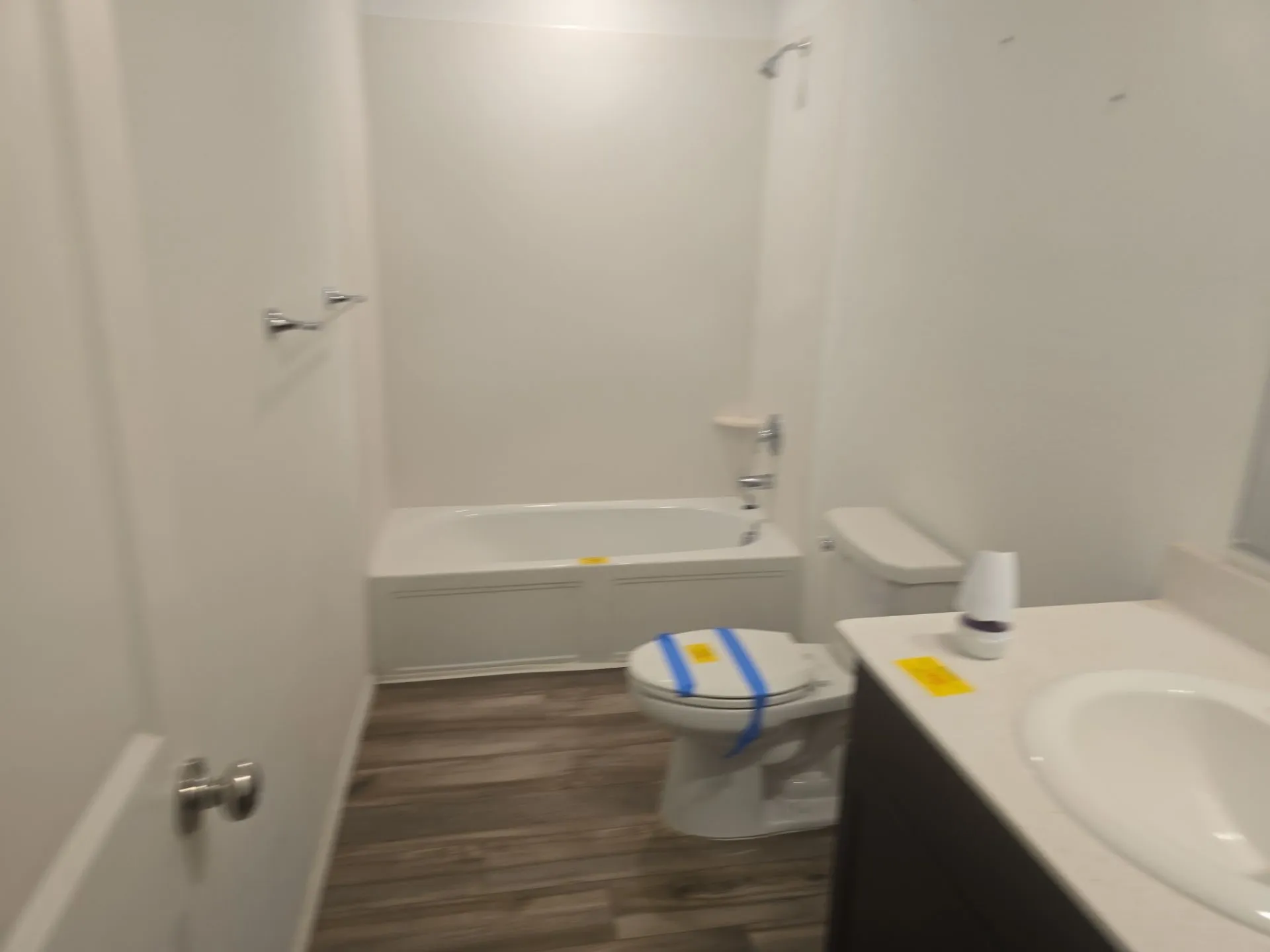 Bathroom with vanity, wood finished floors, and bathing tub / shower combination