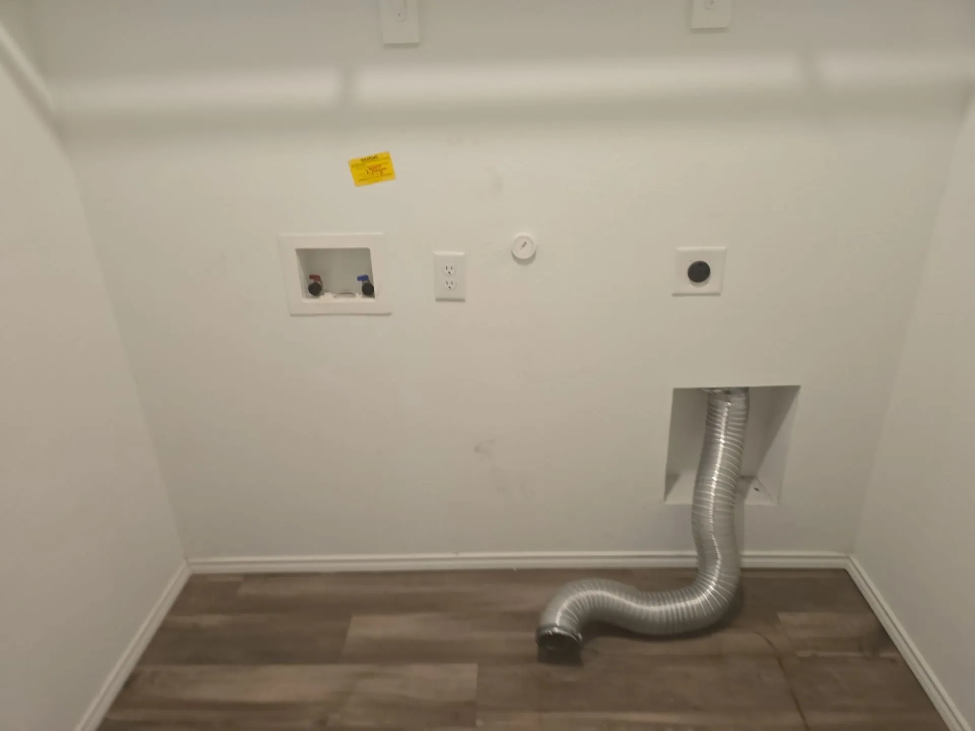 Washroom with hookup for an electric dryer, washer hookup, wood finished floors, and gas dryer hookup