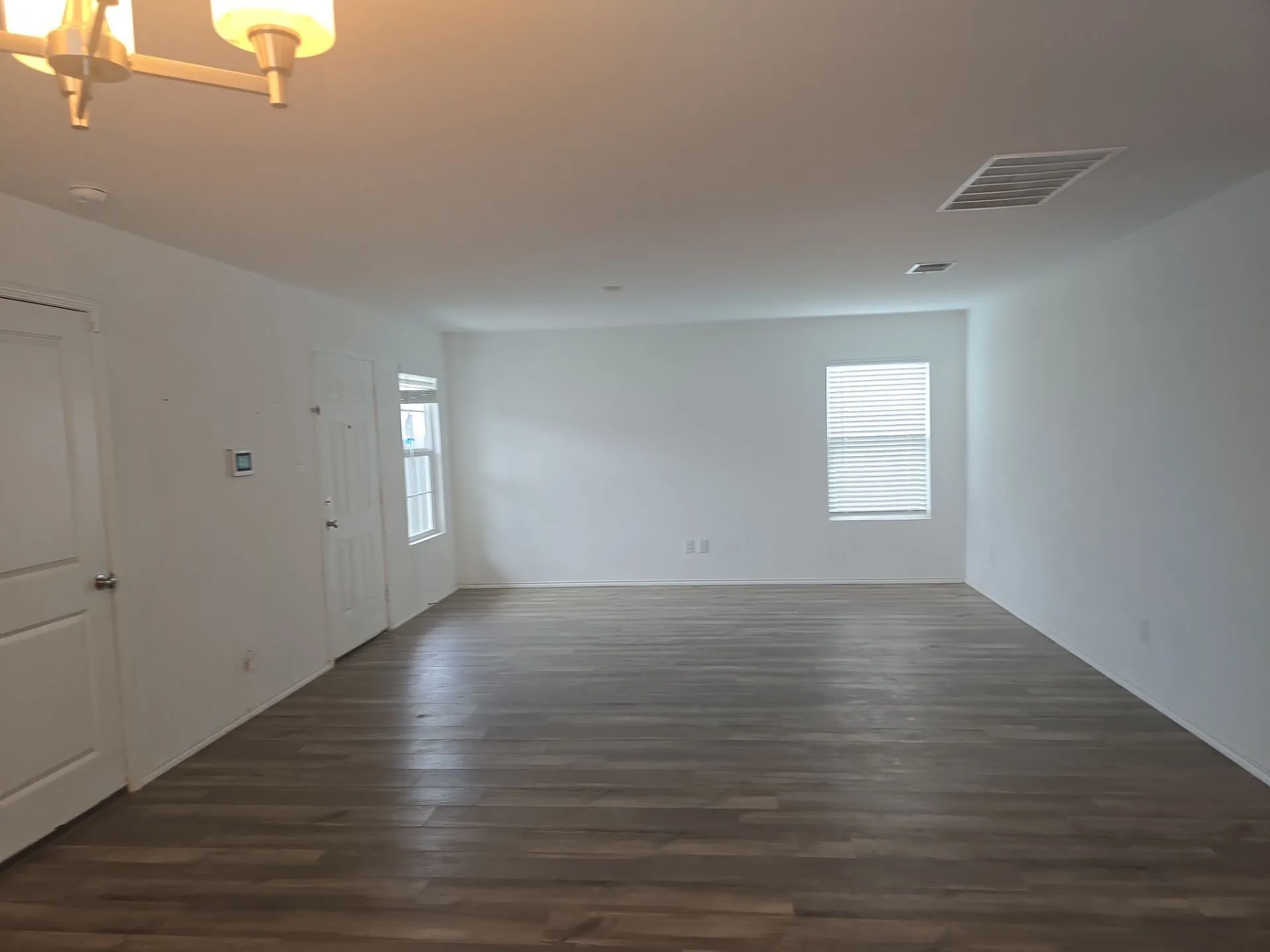 Spare room featuring dark wood-style floors and a smoke detector