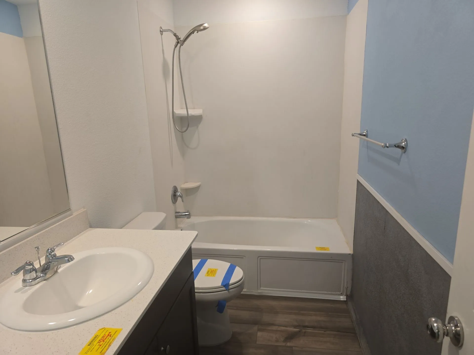 Bathroom featuring vanity, wood finished floors, and shower / bathtub combination