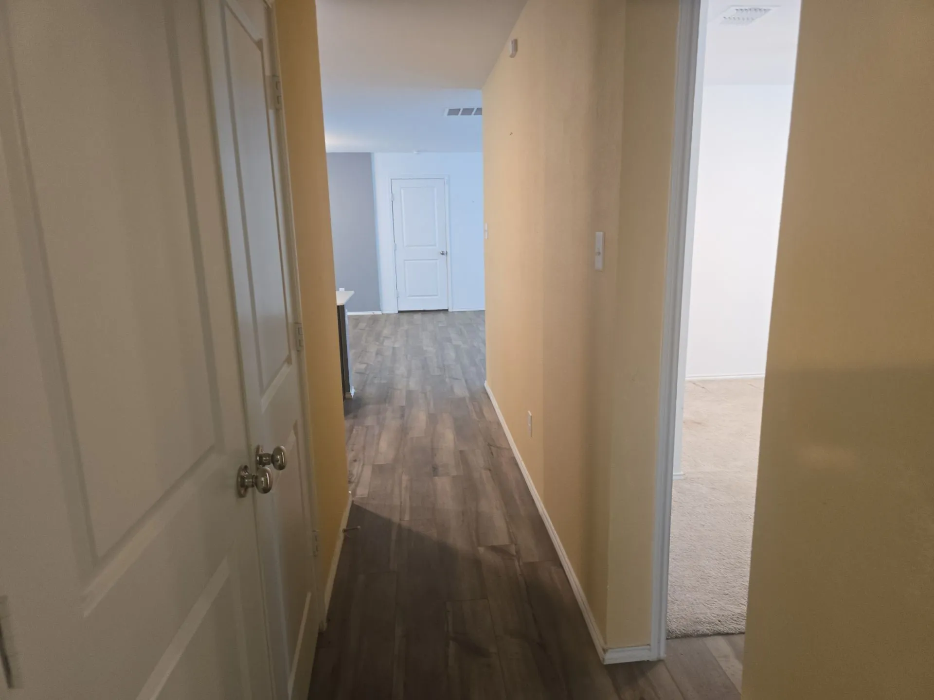 Hallway with dark wood finished floors