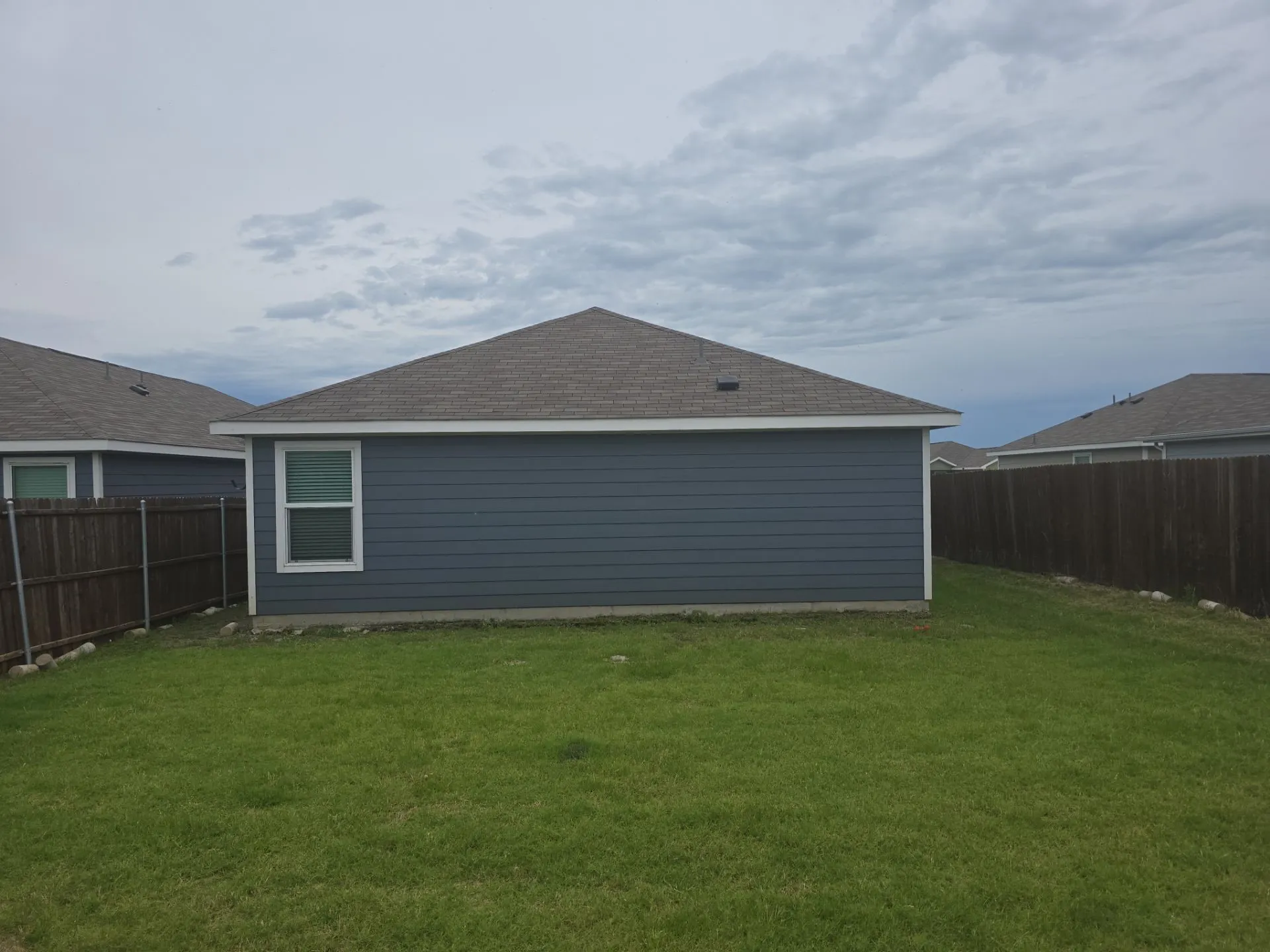 Back of property with a fenced backyard