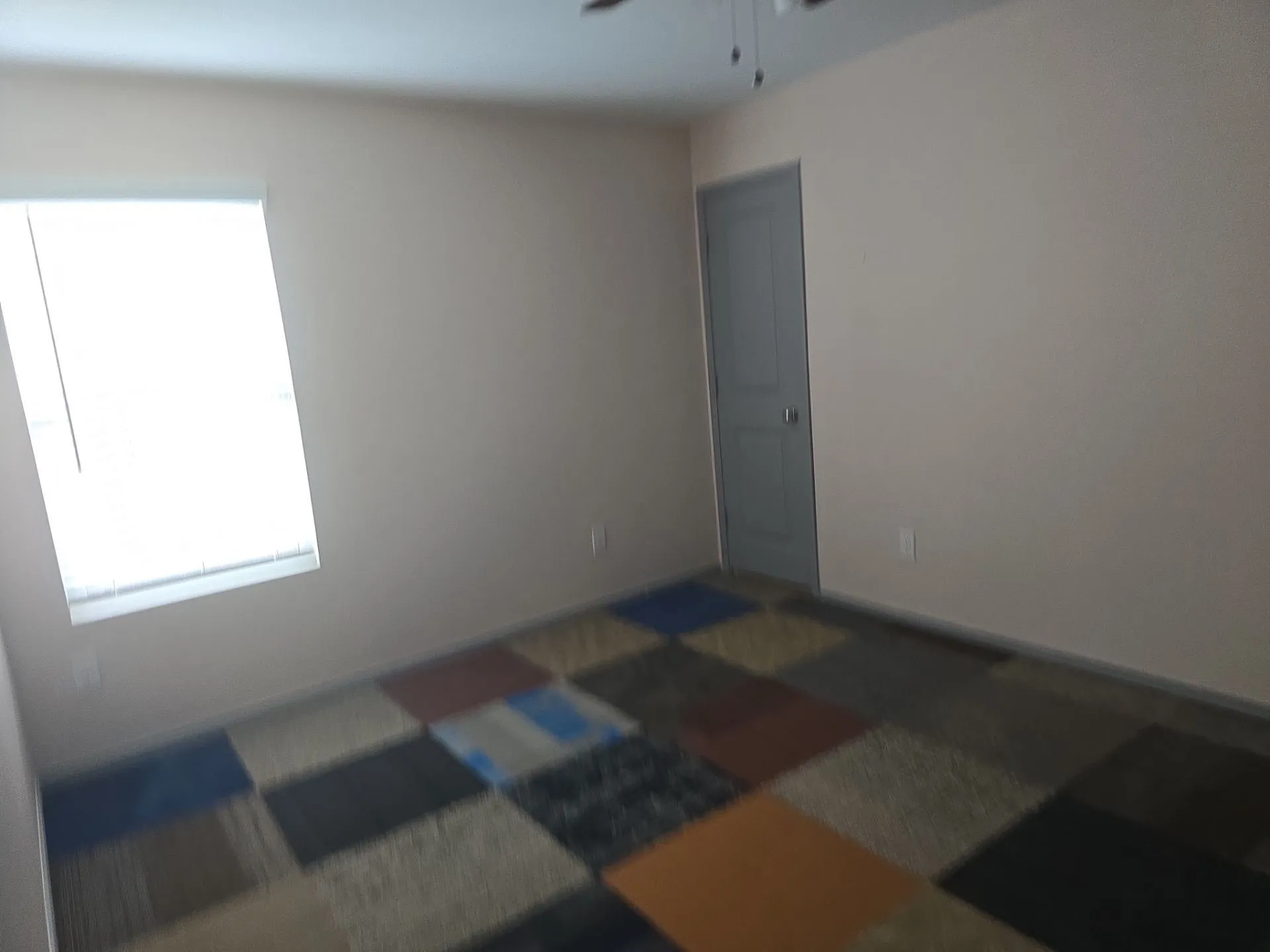 Spare room with ceiling fan and baseboards