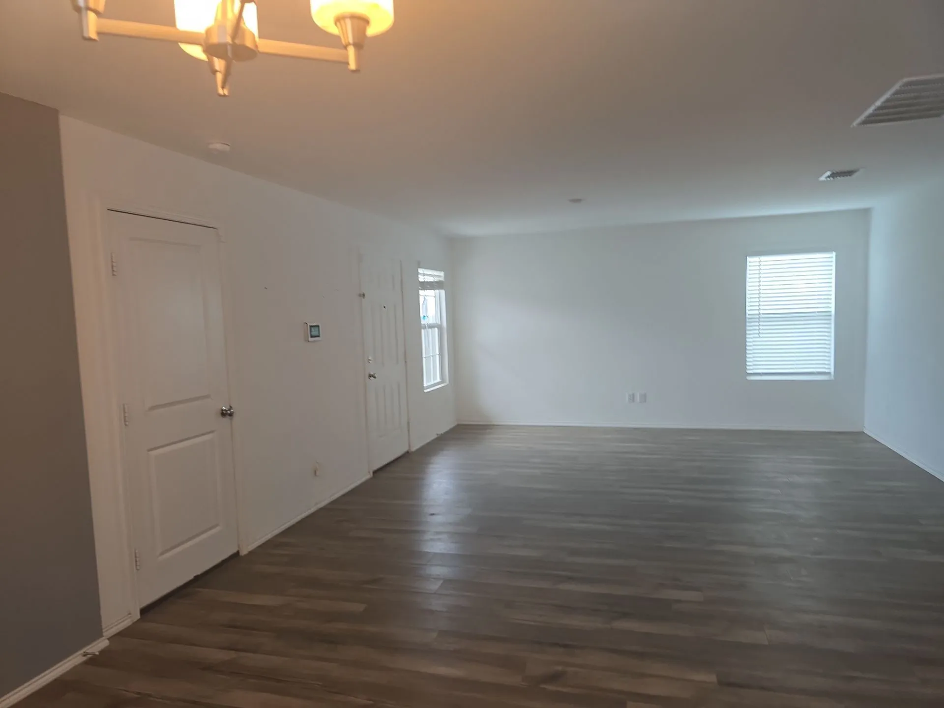 Empty room featuring dark wood finished floors