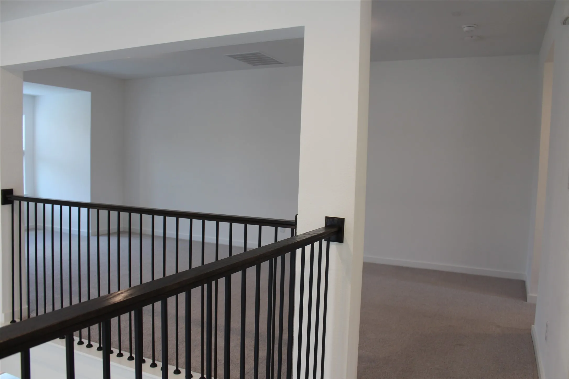 Hall with an upstairs landing and carpet floors