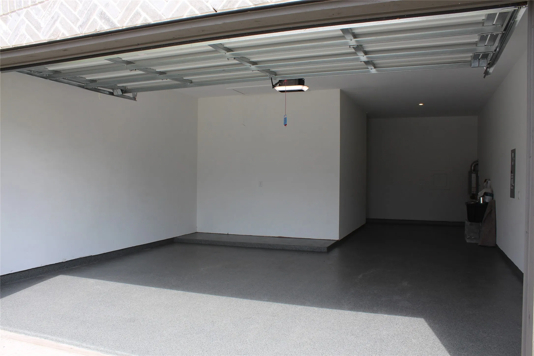 Garage featuring a garage door opener