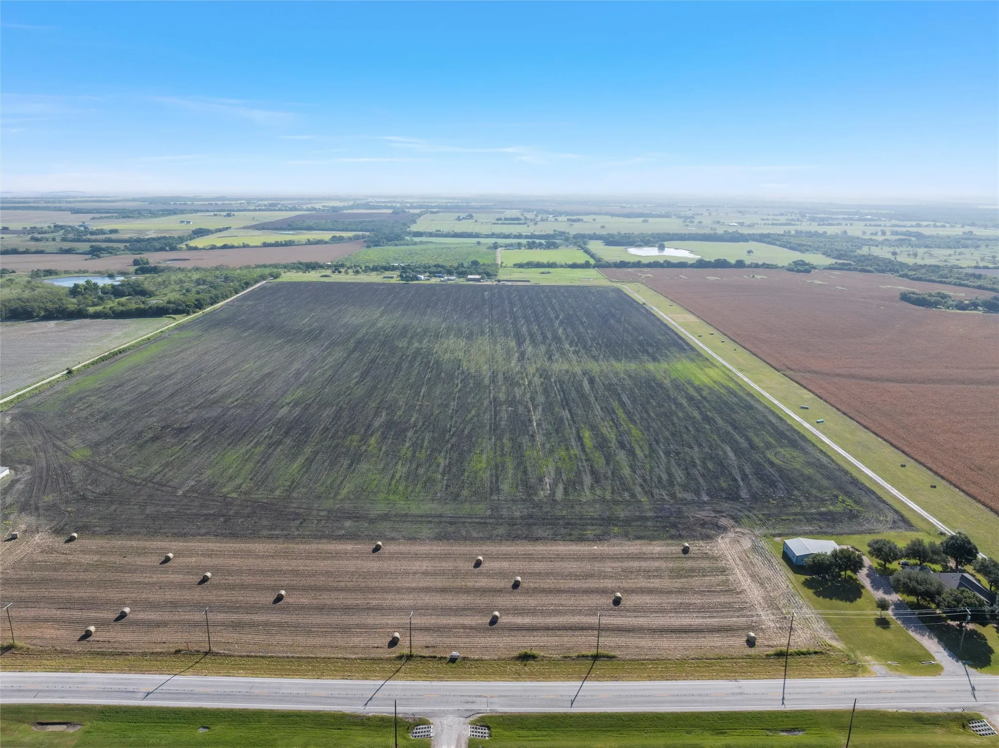 Aerial view of sparsely populated area with large plots for crops