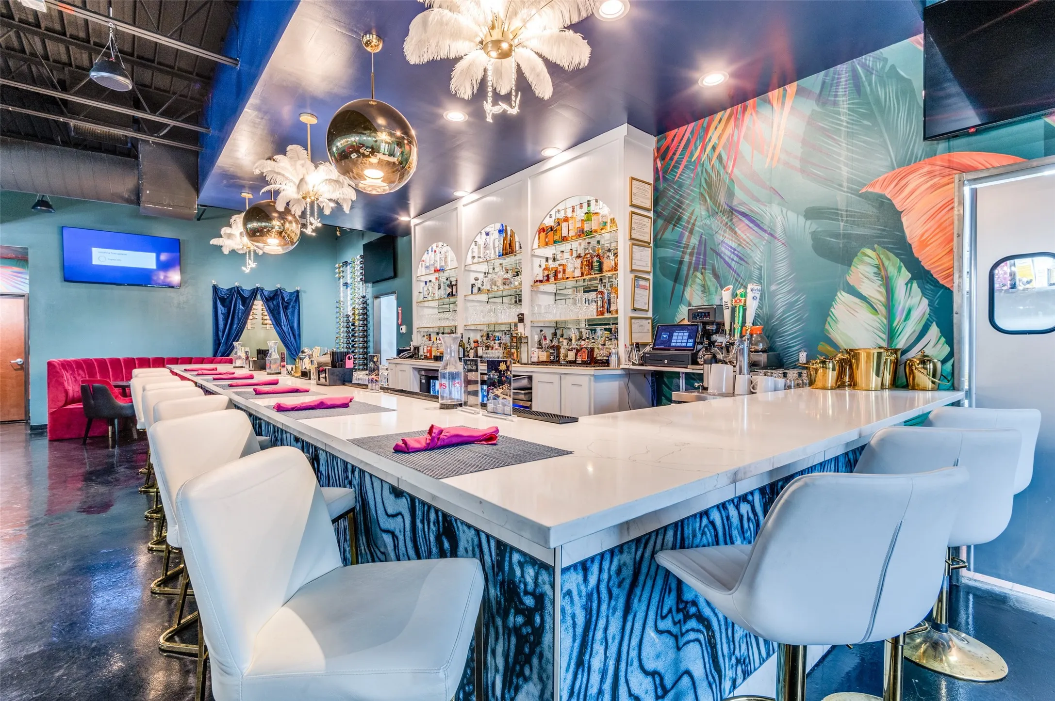 Bar with concrete flooring and a chandelier