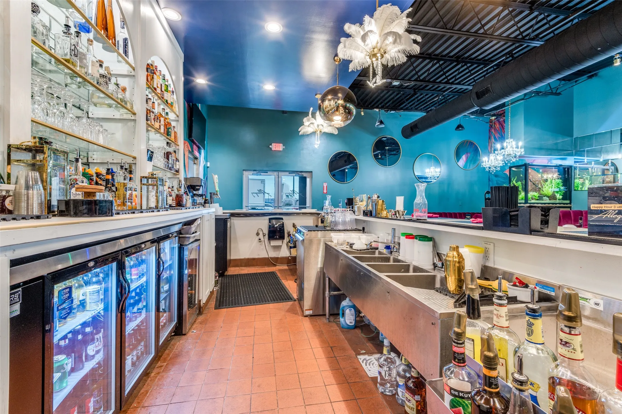 Bar with beverage cooler, a chandelier, tile patterned floors, and recessed lighting