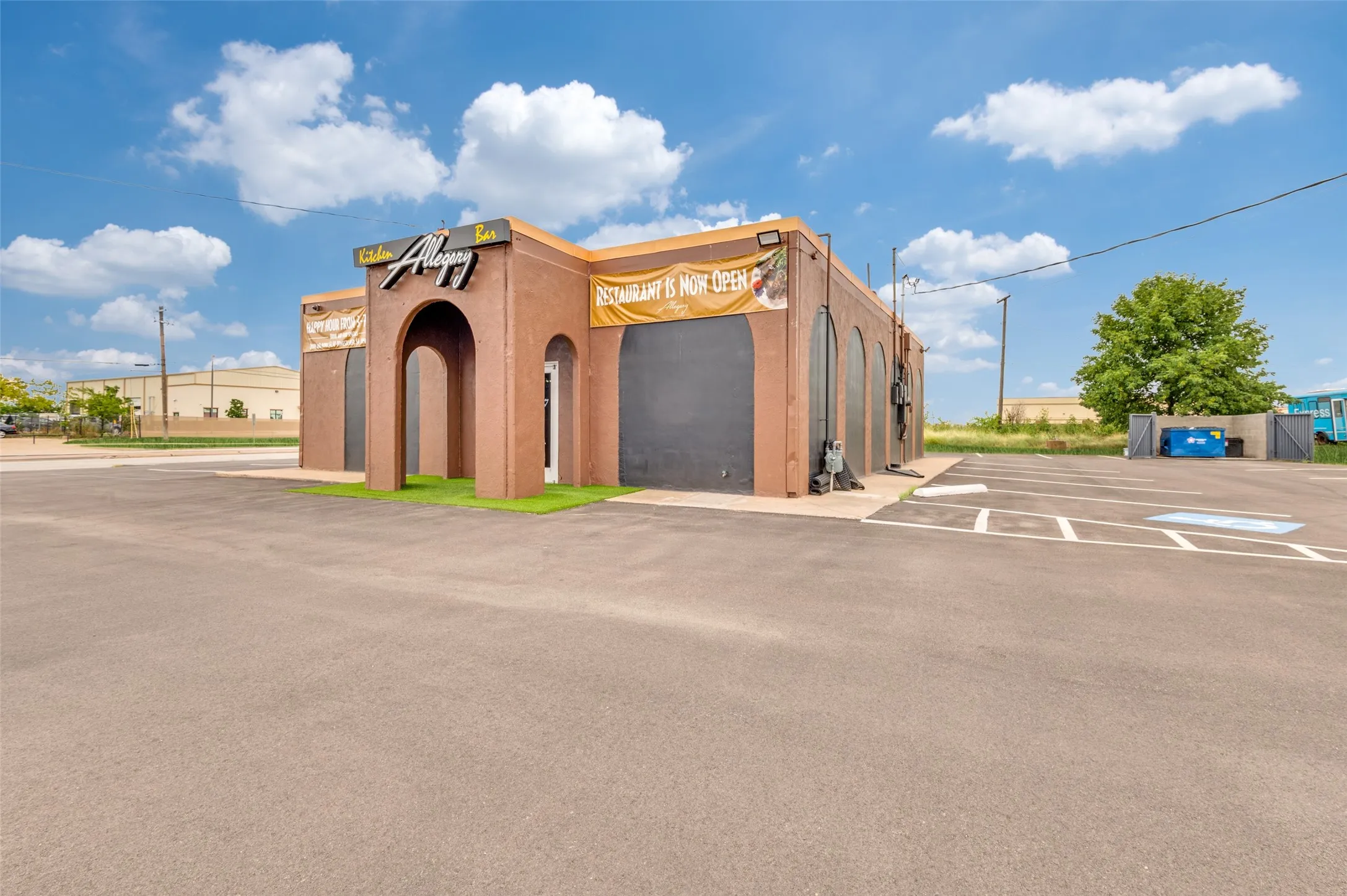 View of building exterior featuring uncovered parking