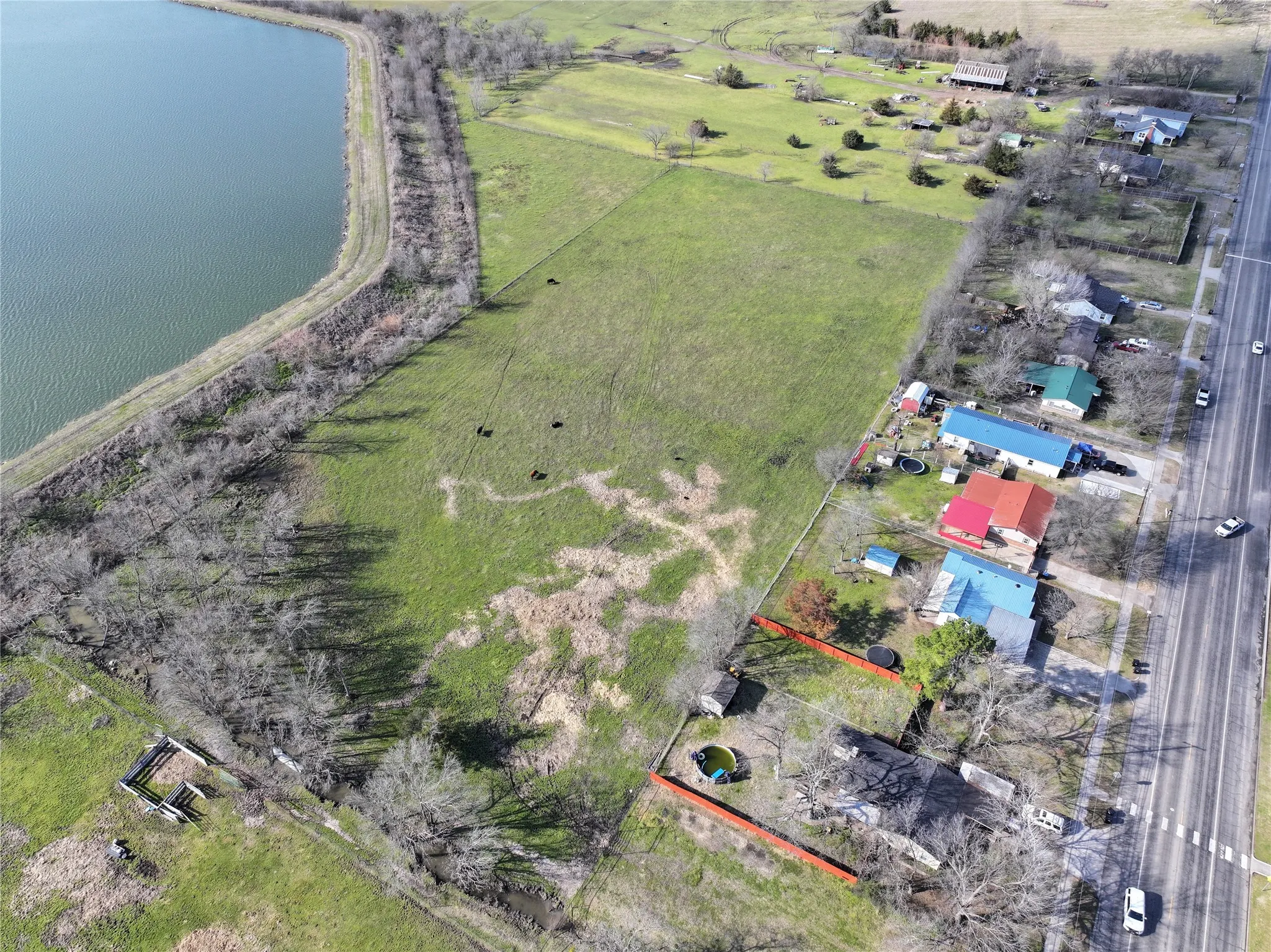 Overview of rural landscape with a large body of water and property parcel outlined