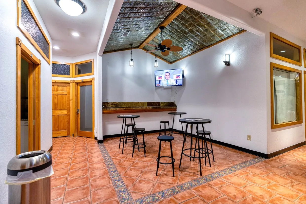 Tiled dining space featuring ceiling fan and lofted ceiling