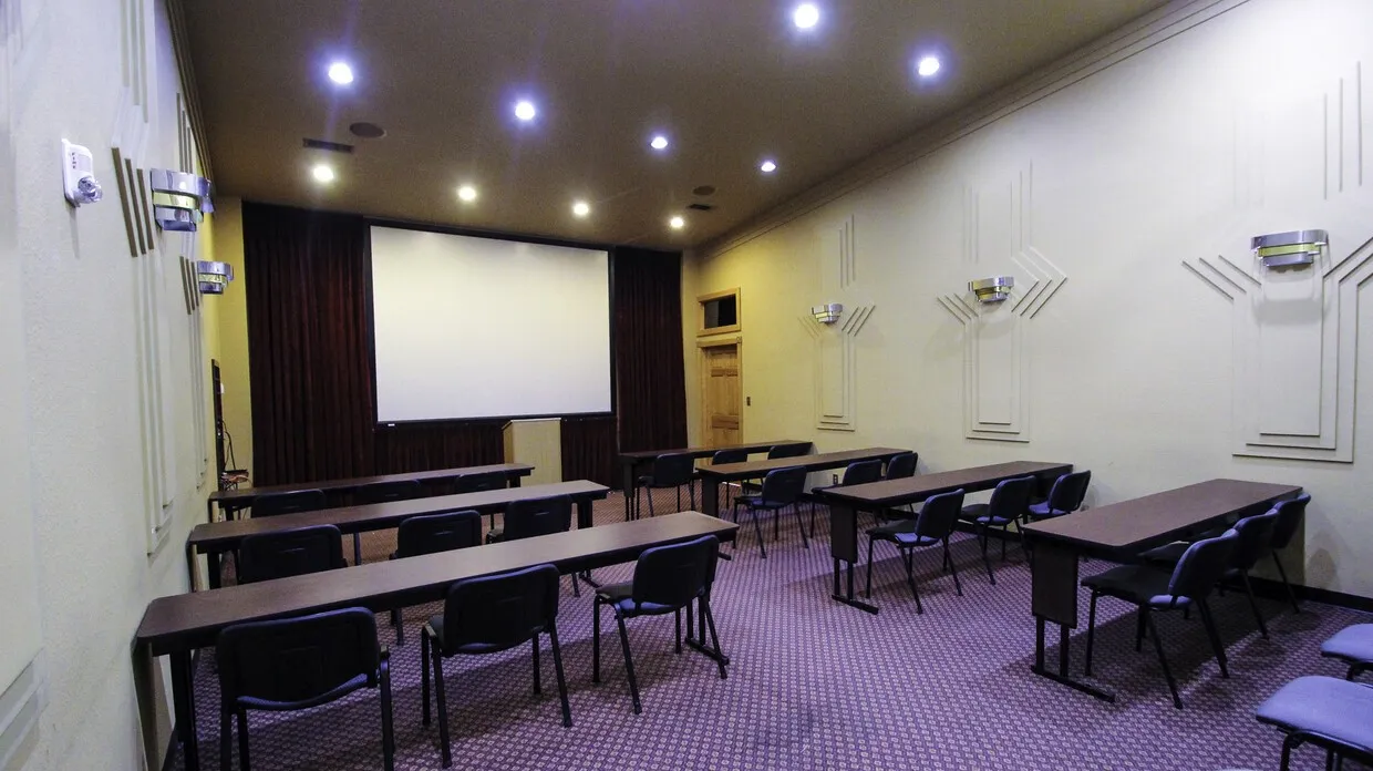 Carpeted home theater with recessed lighting and ornamental molding