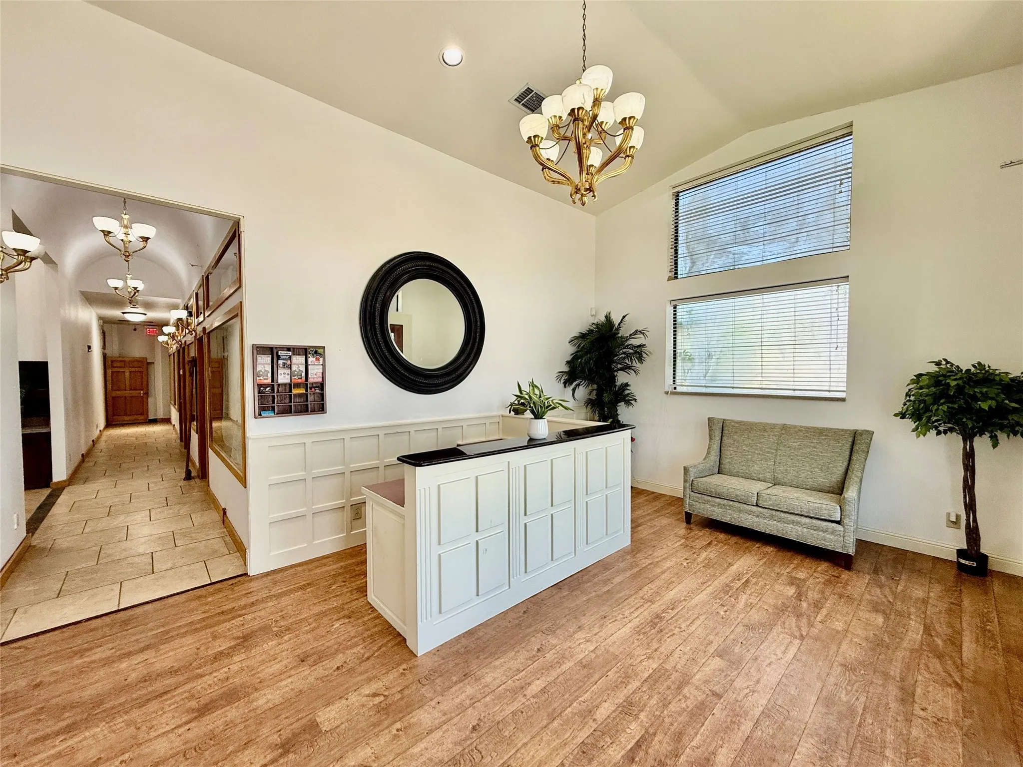 Sitting room featuring a chandelier, light wood-style floors, high vaulted ceiling, and recessed lighting
