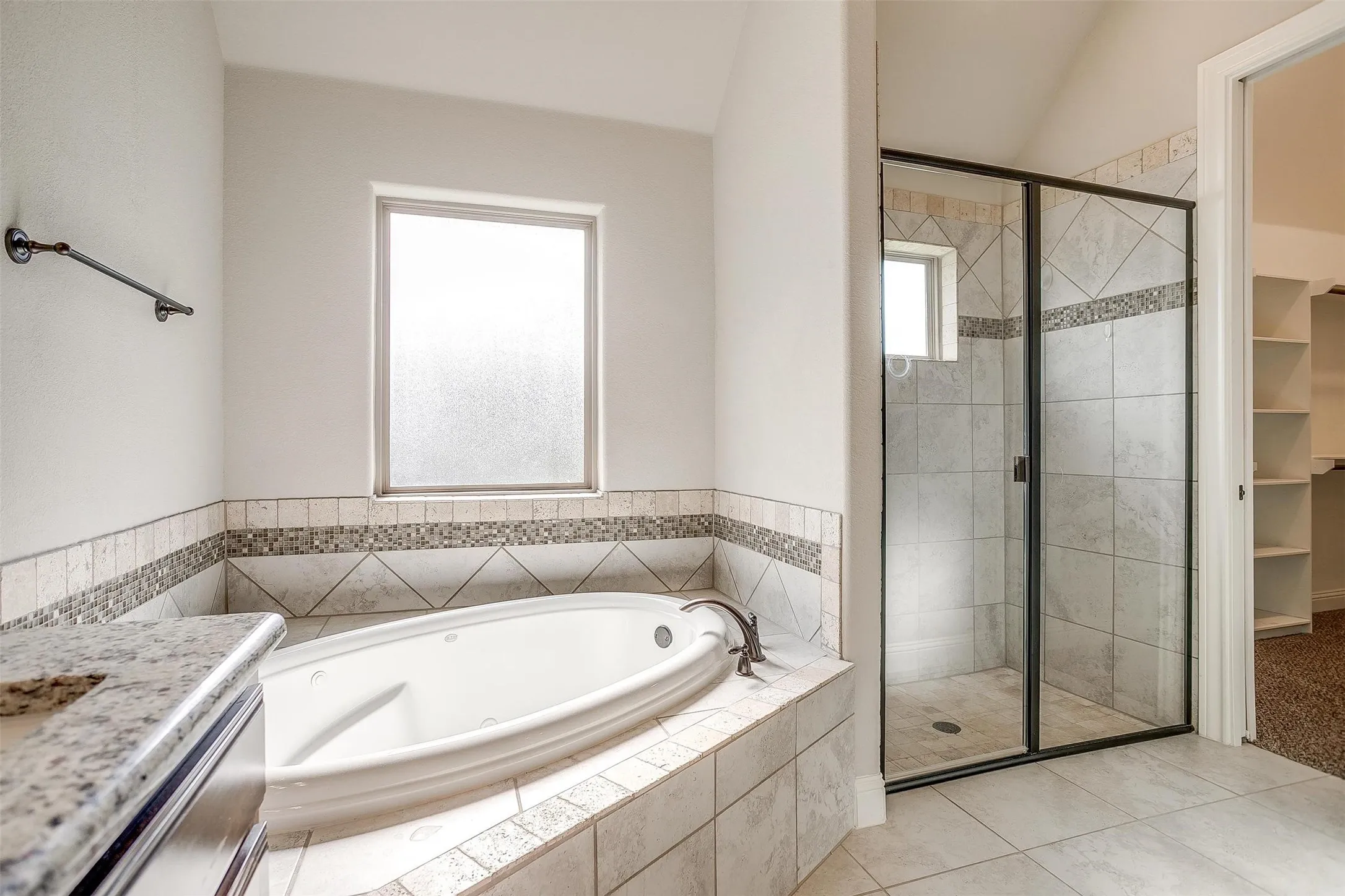 Bathroom featuring a jetted tub, a shower stall, vanity, and tile patterned flooring