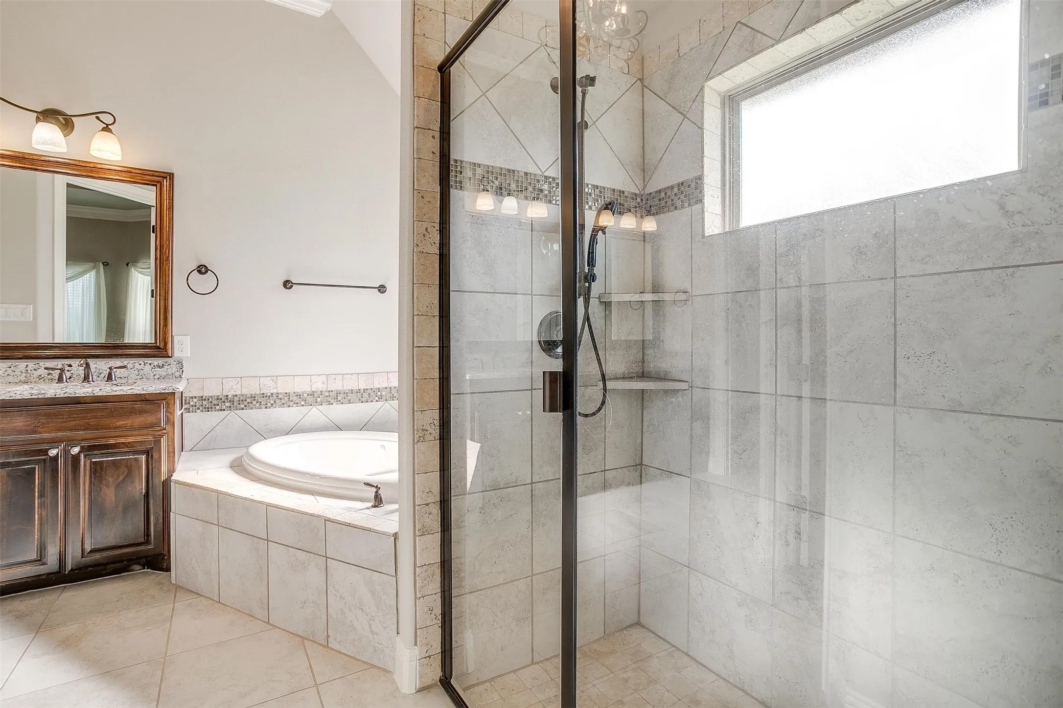 Bathroom featuring a garden tub, a stall shower, vanity, and tile patterned floors