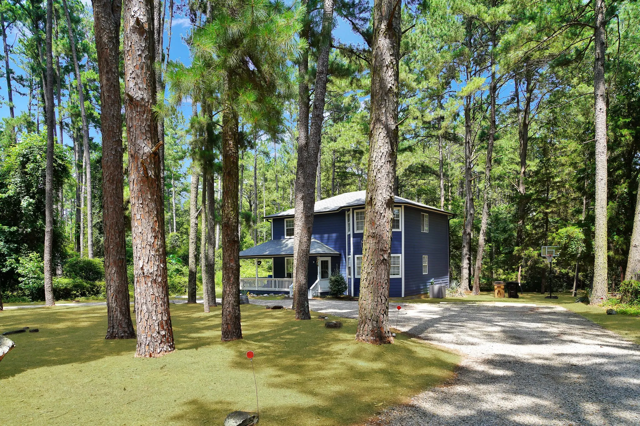 View of front of property with gravel driveway and a porch