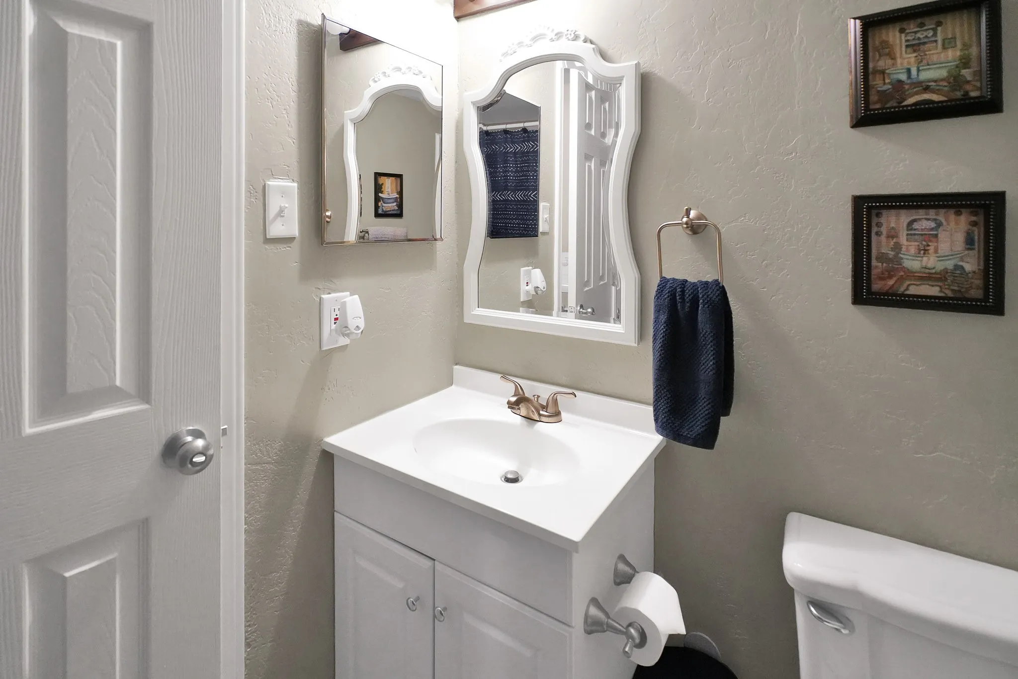 Half bathroom featuring vanity and toilet