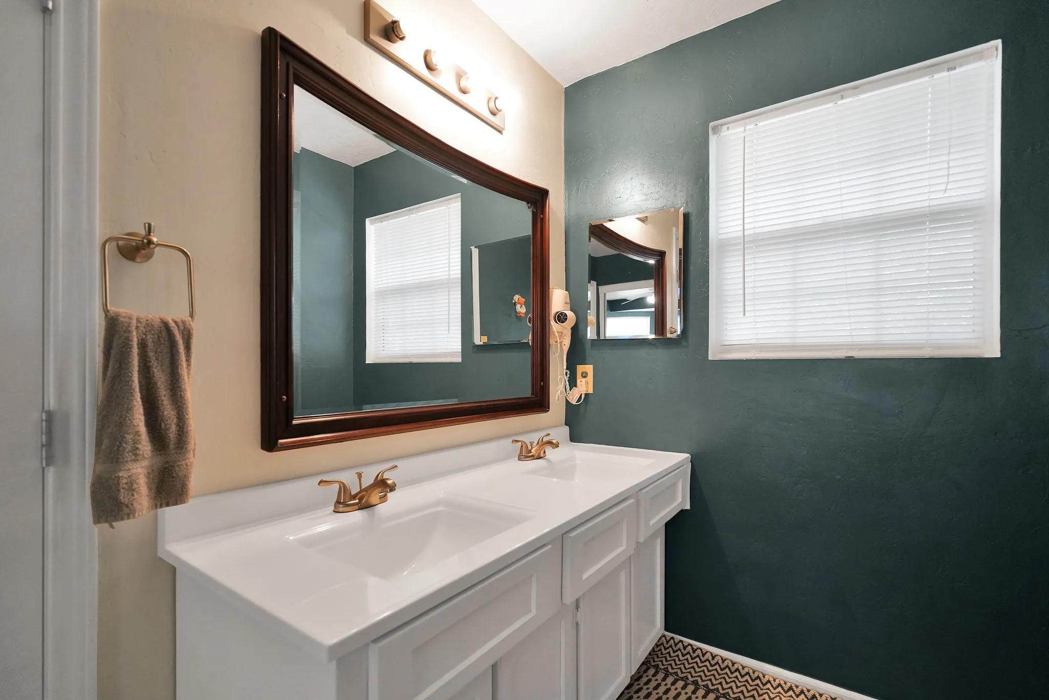 Bathroom featuring double vanity and healthy amount of natural light