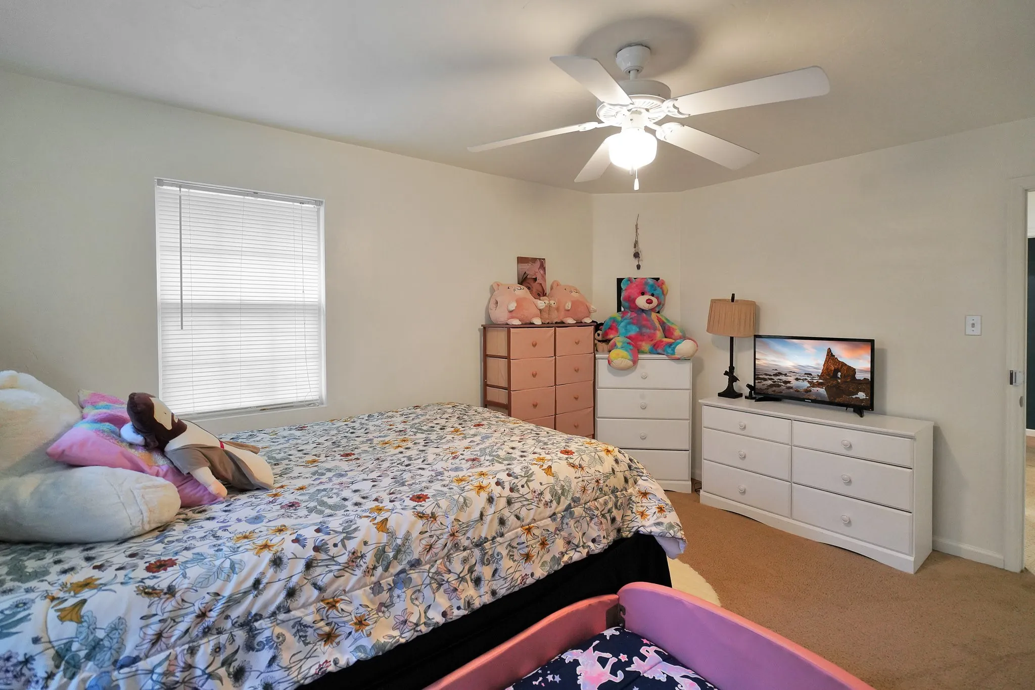 Bedroom featuring light colored carpet and ceiling fan