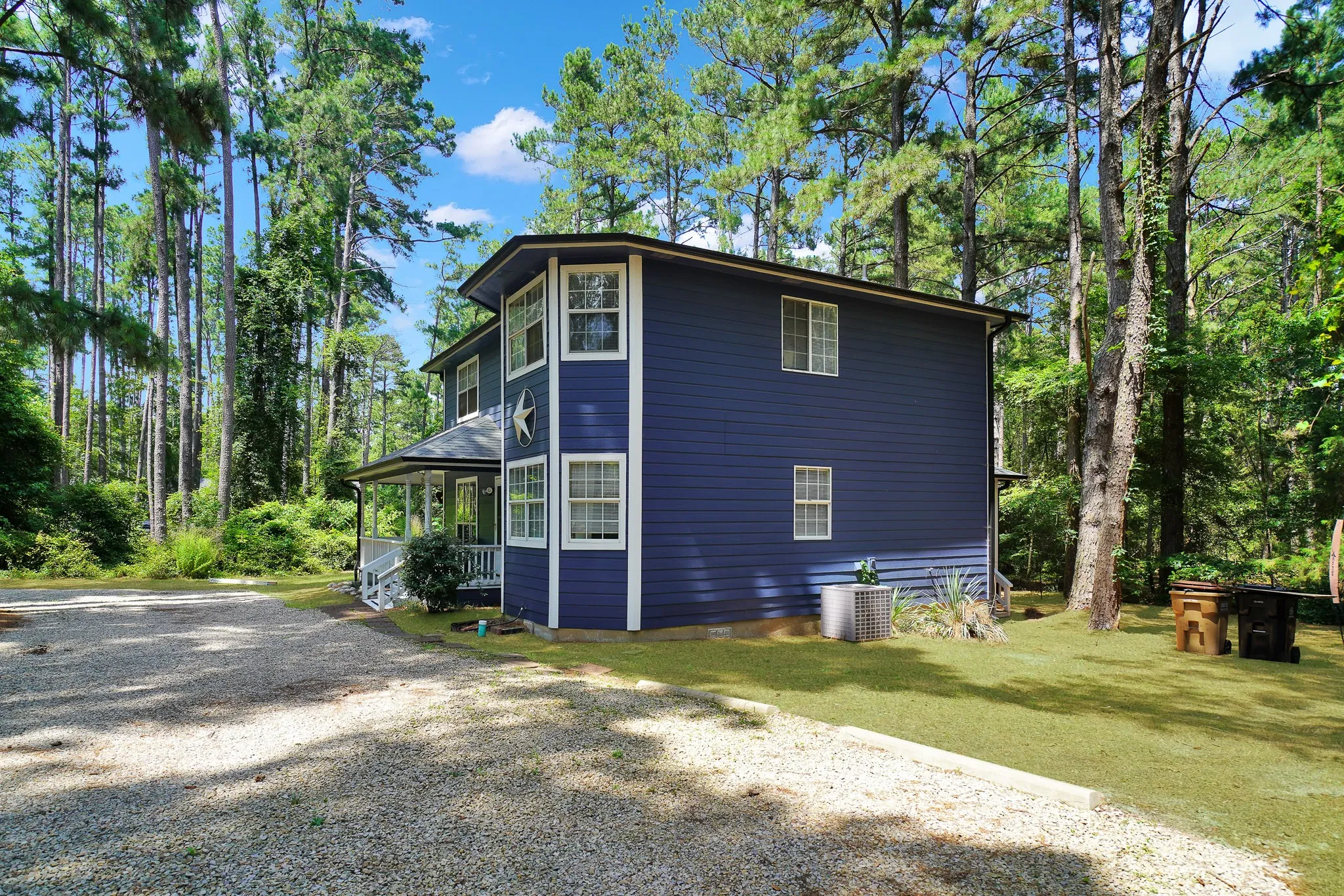 View of side of property with driveway and a porch