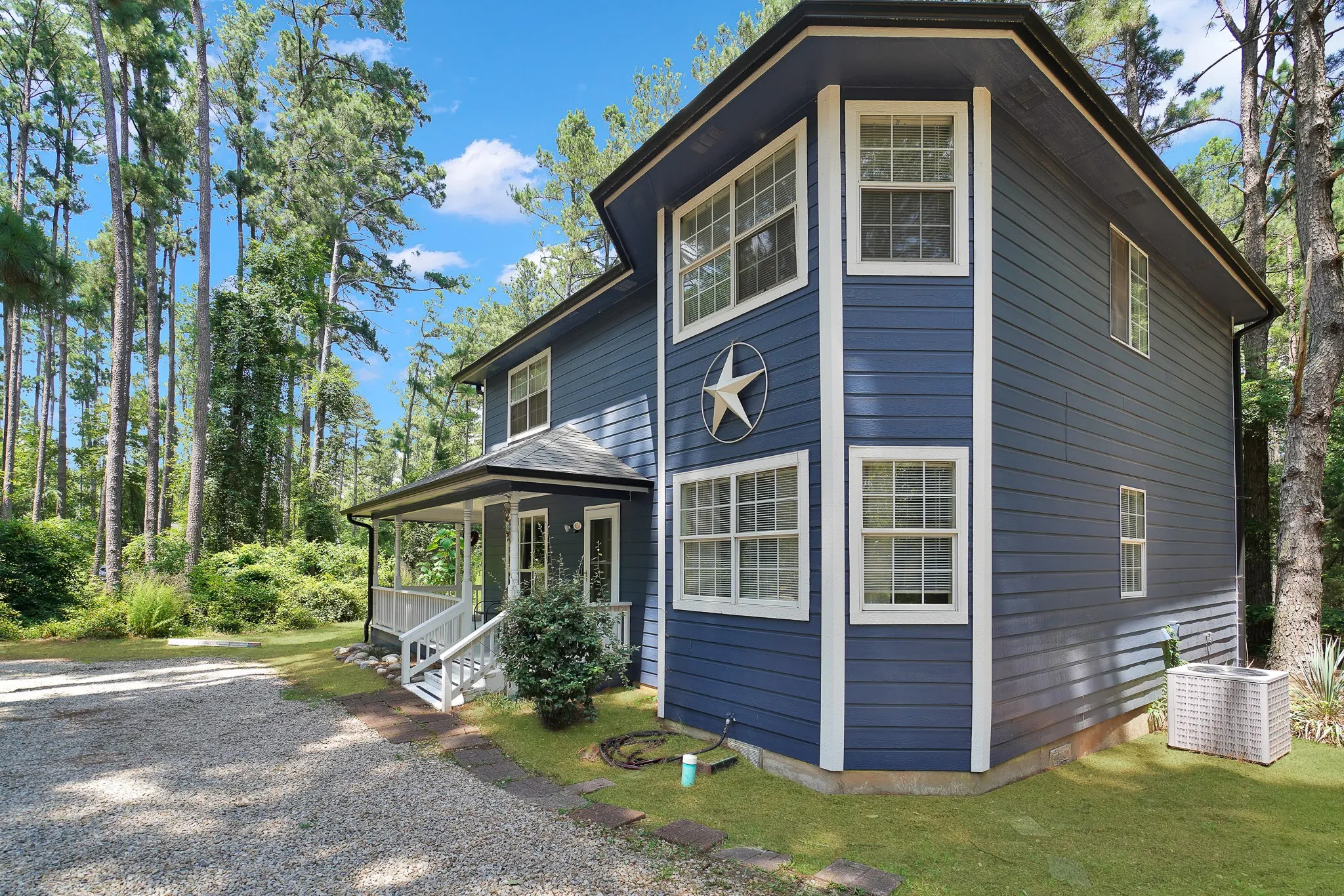 View of home's exterior with covered porch and a central AC unit
