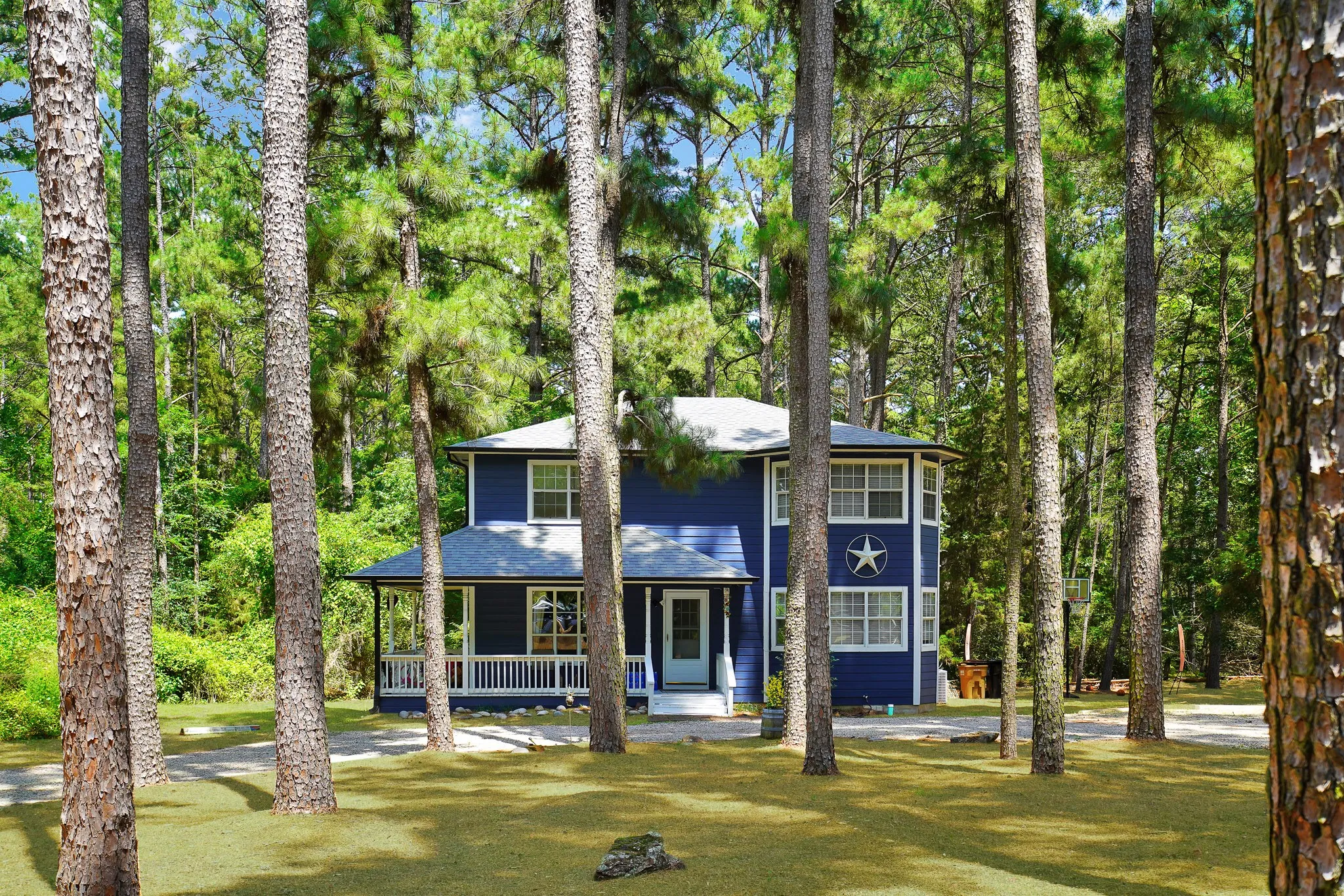 View of front of house with covered porch and a front yard