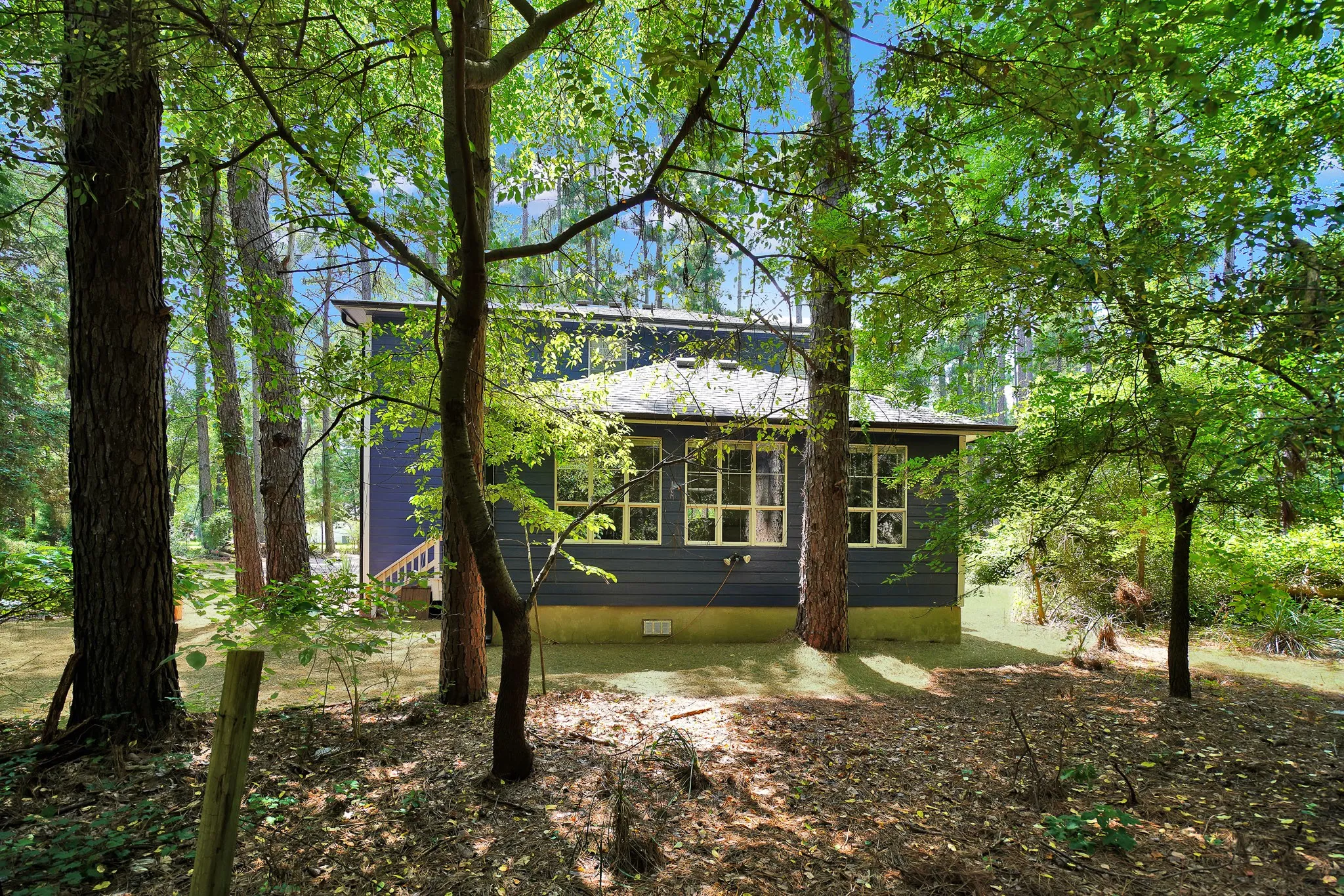 Rear view of property featuring crawl space