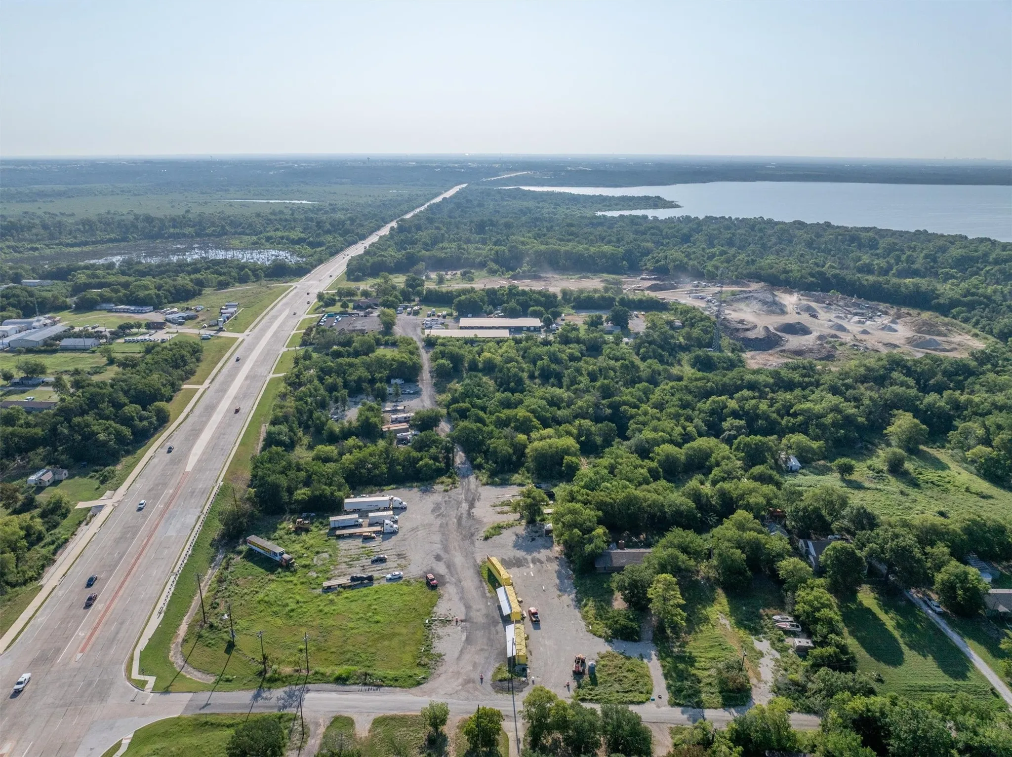 Aerial overview of property's location featuring a nearby body of water and a main thoroughfare