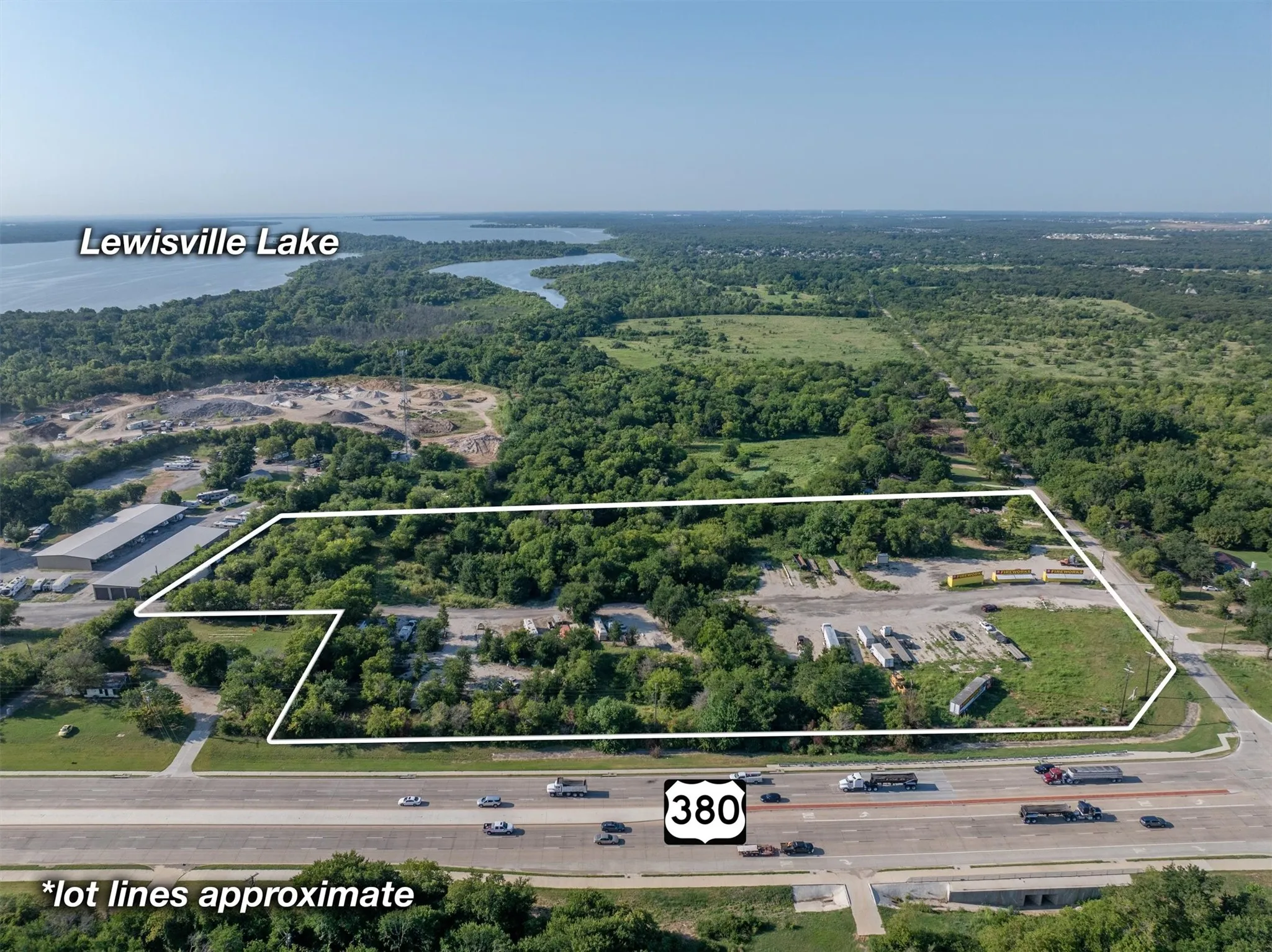Aerial view of property and surrounding area featuring a nearby body of water and property boundaries highlighted