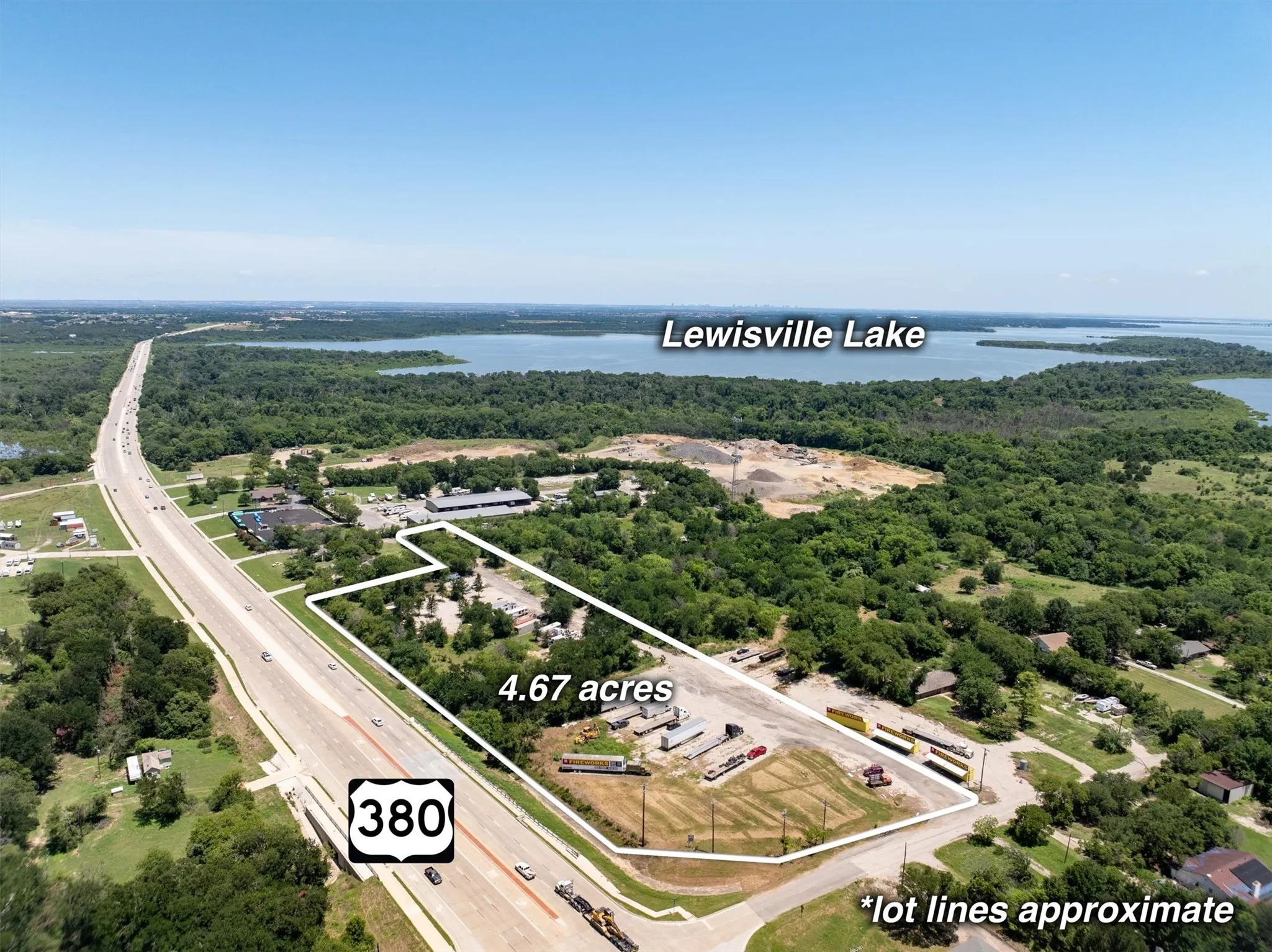Aerial view of property and surrounding area with a large body of water and property parcel outlined