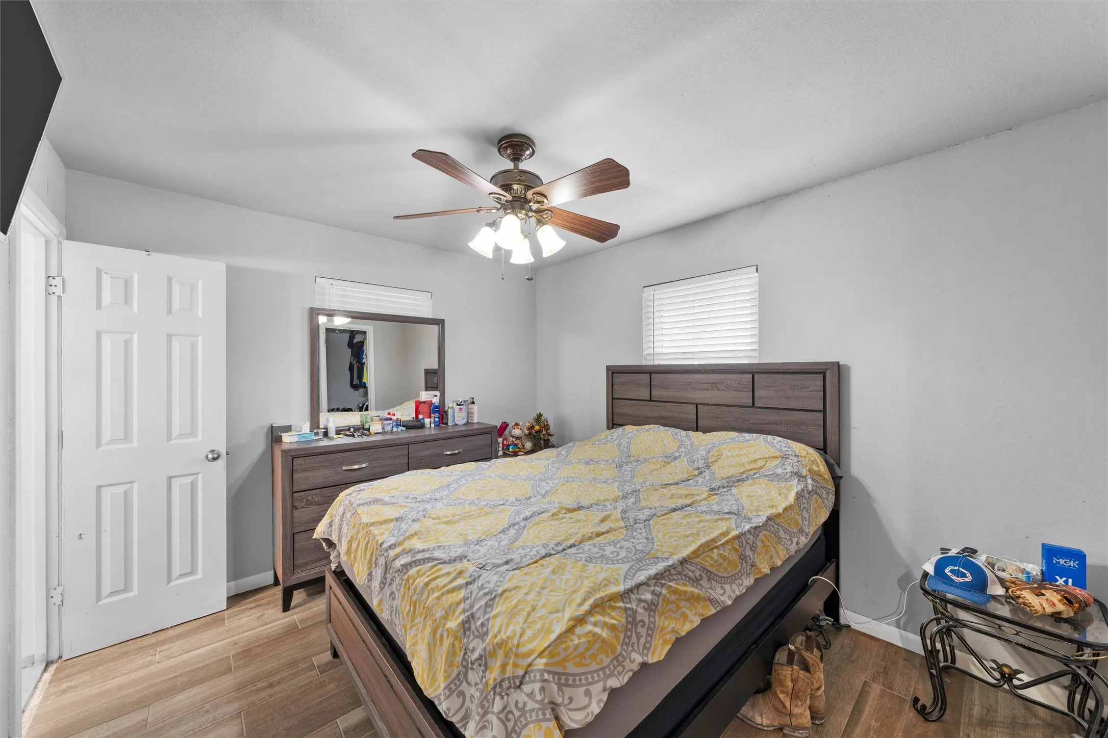 Bedroom with light wood finished floors and a ceiling fan