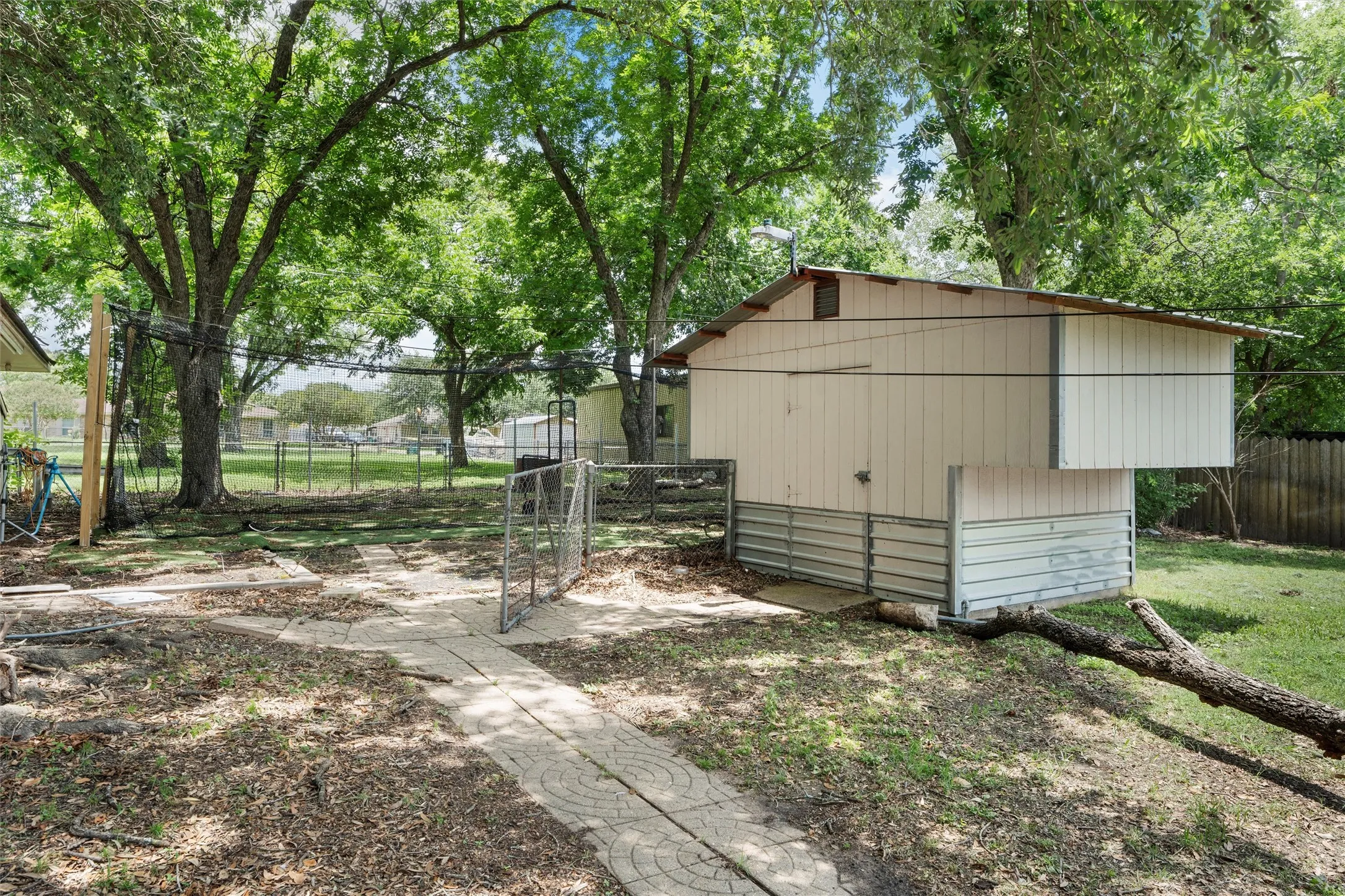 View of outbuilding with a gate