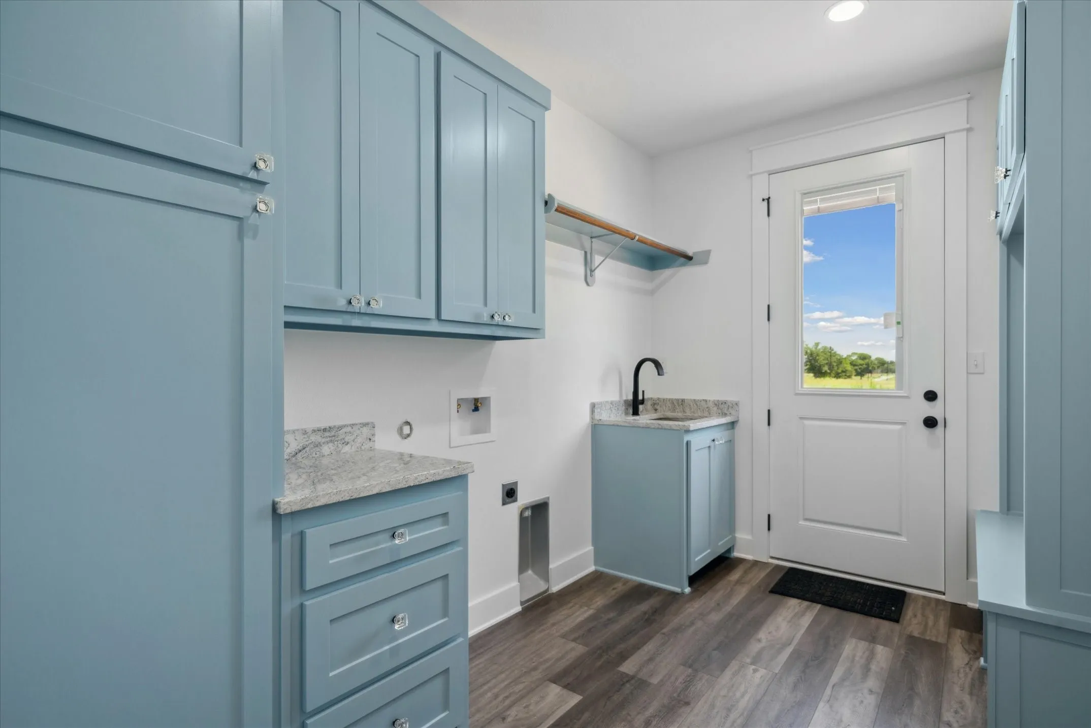 Washroom featuring electric dryer hookup, washer hookup, cabinet space, dark wood-type flooring, and recessed lighting