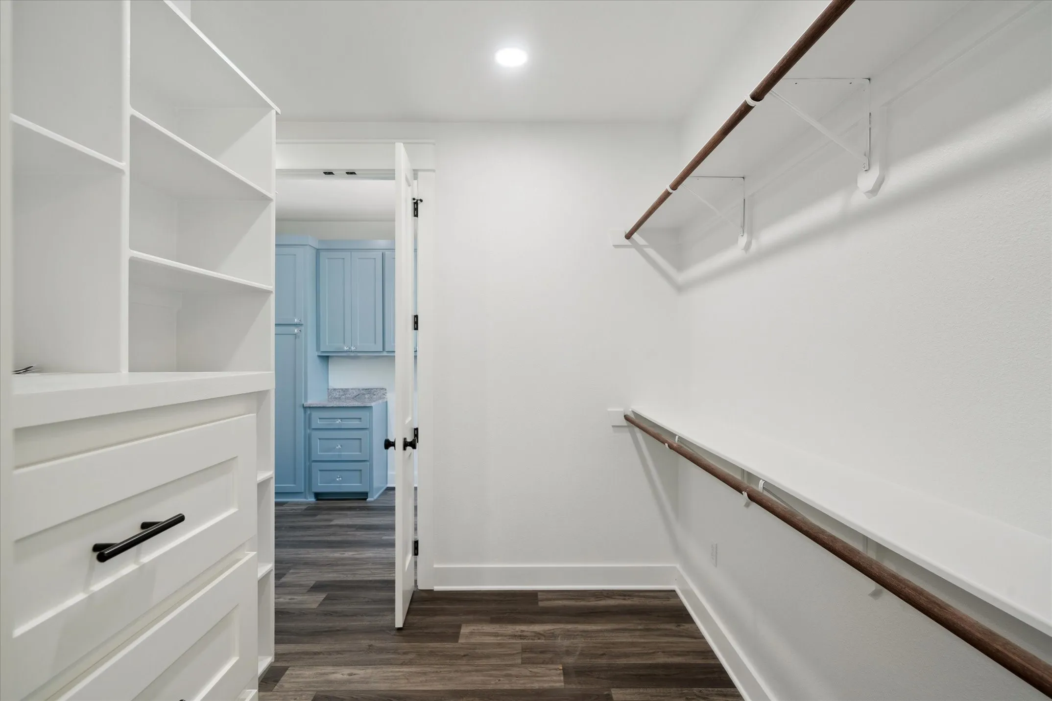 Walk in closet featuring dark wood finished floors