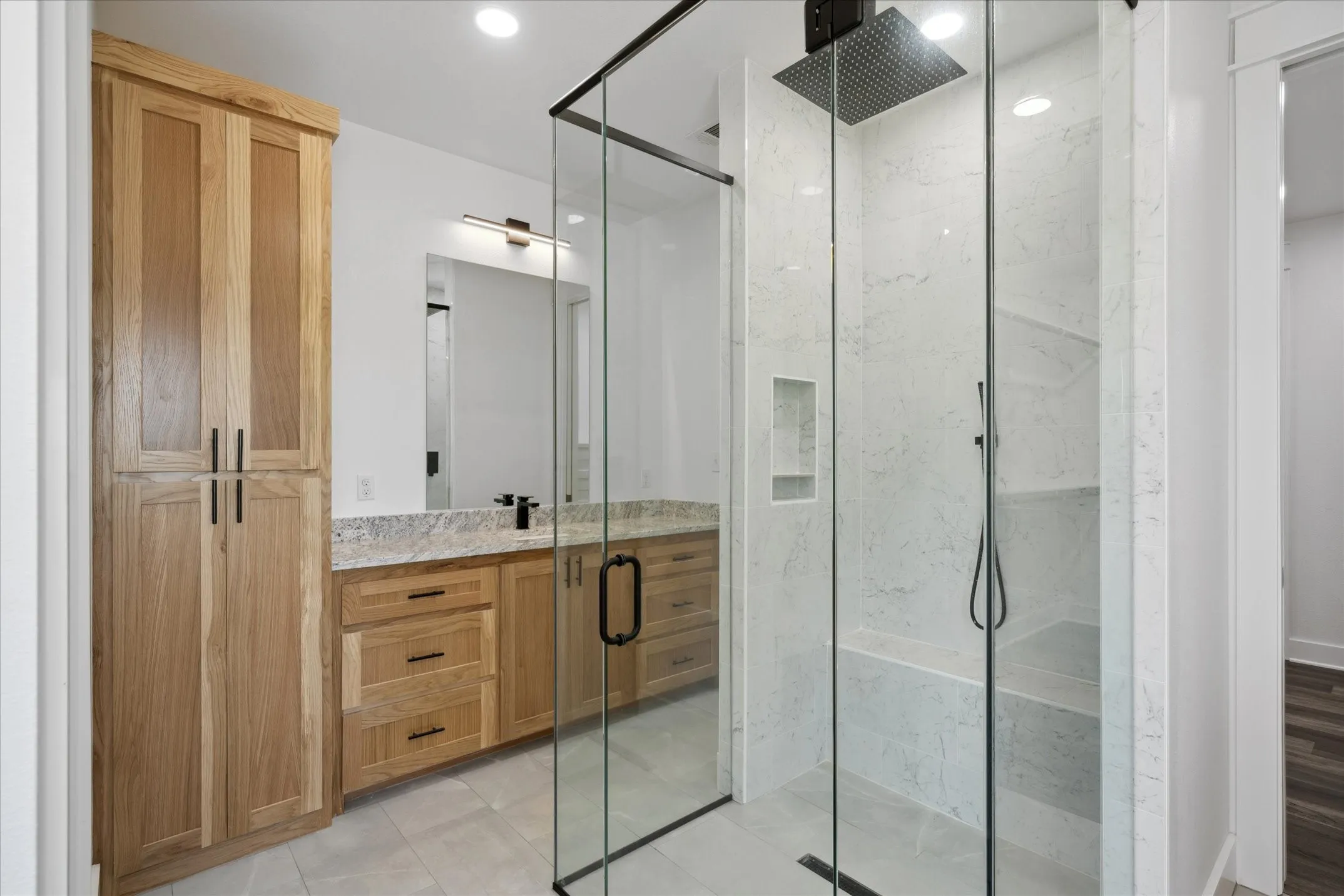 Bathroom featuring a marble finish shower, vanity, tile patterned flooring, and recessed lighting