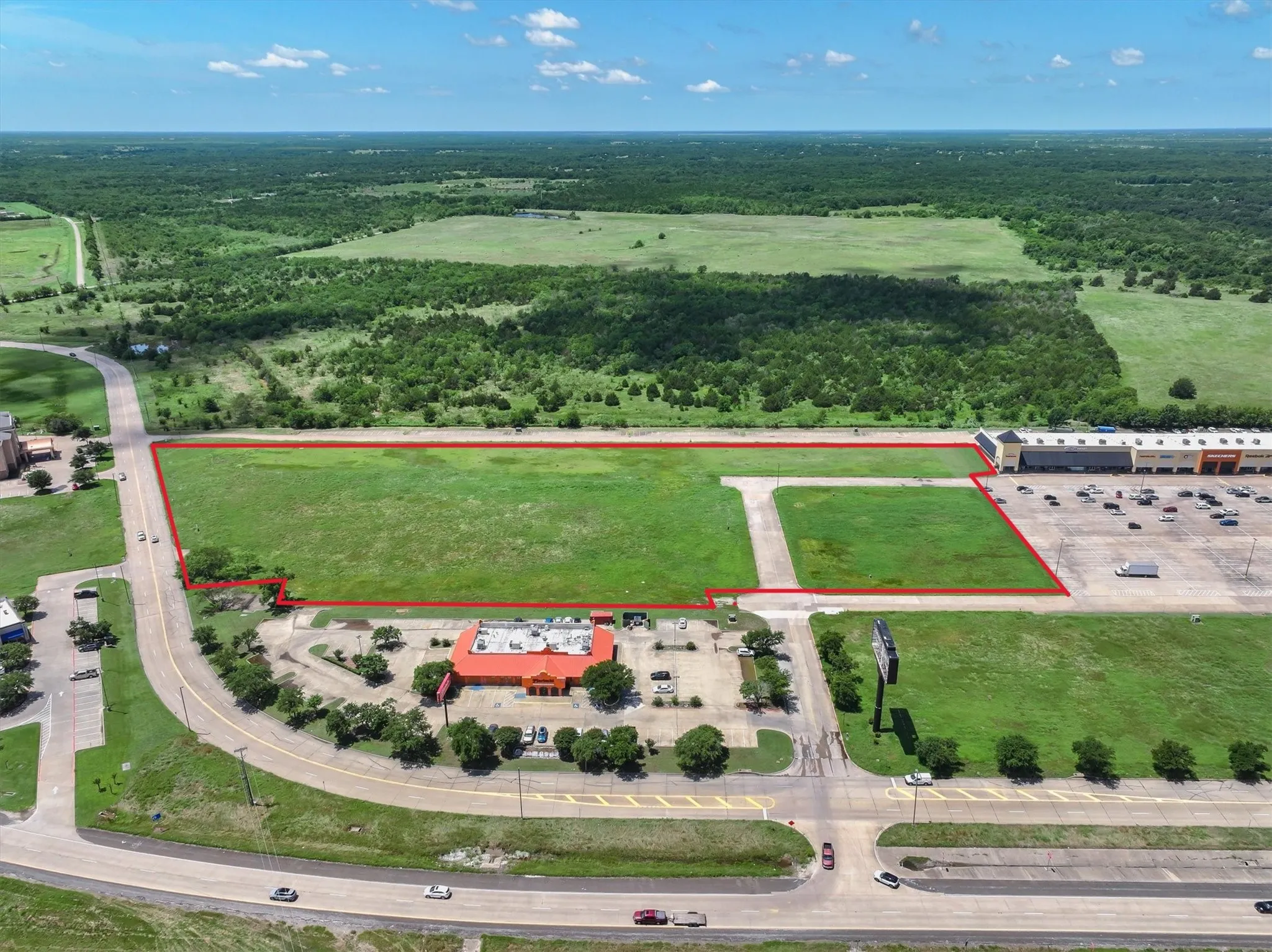 View of property location with property boundaries highlighted and a forest