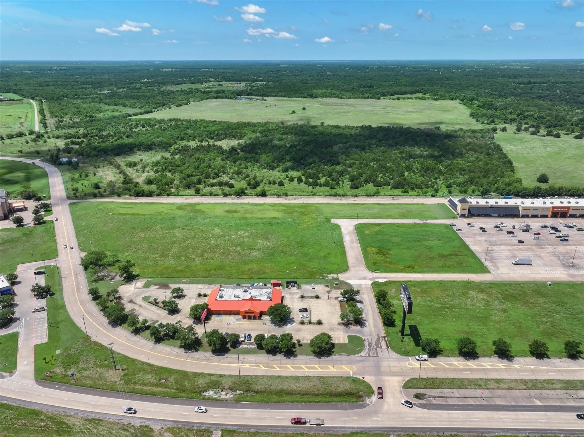 Aerial overview of property's location featuring a forest