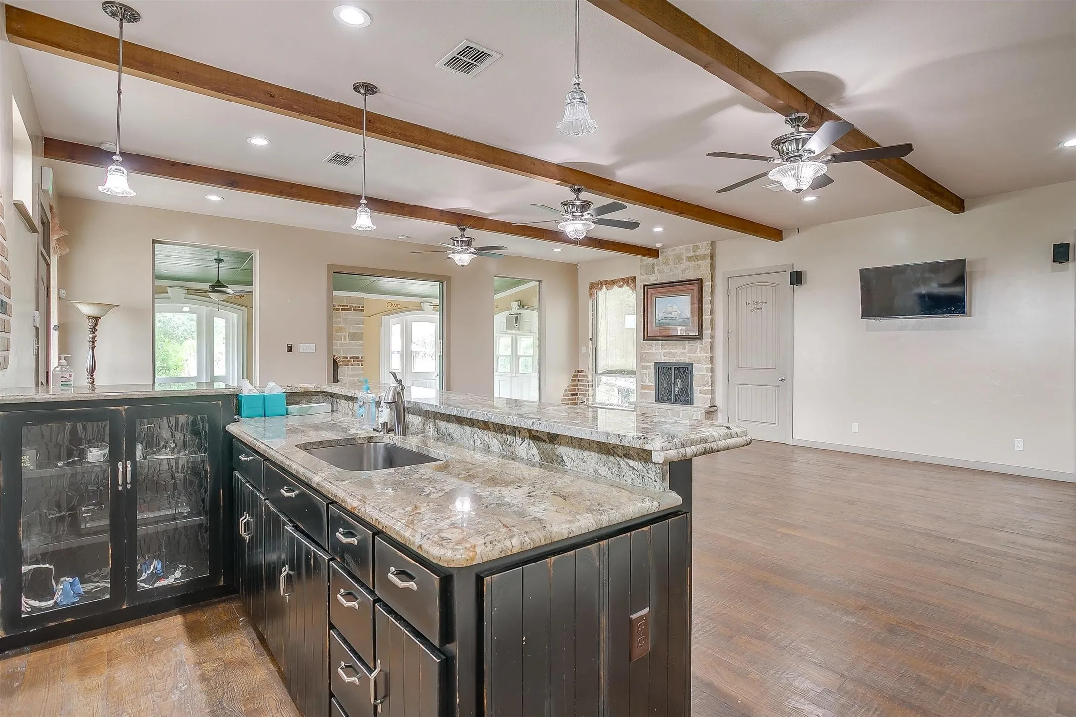 EVENT CENTER- Kitchen featuring double oven, marble counters, sink and dishwasher. Door to walk-in pantry.
