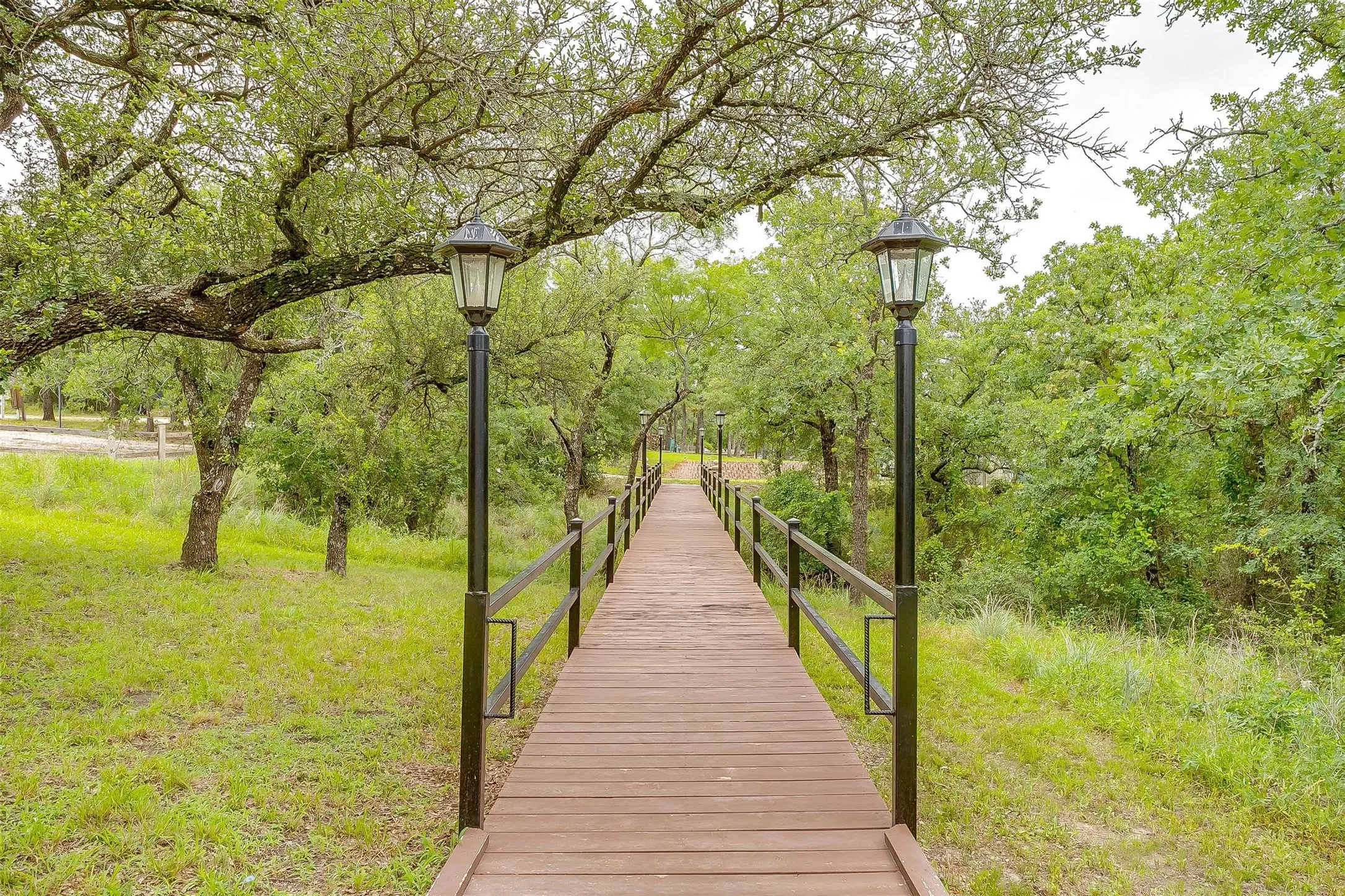 View of property's community bridge for walking to event center from cabins.